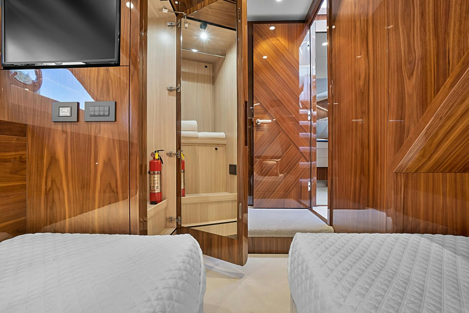 a room with a bed and a glass door aboard YOUNG HEARTS Yacht for Sale