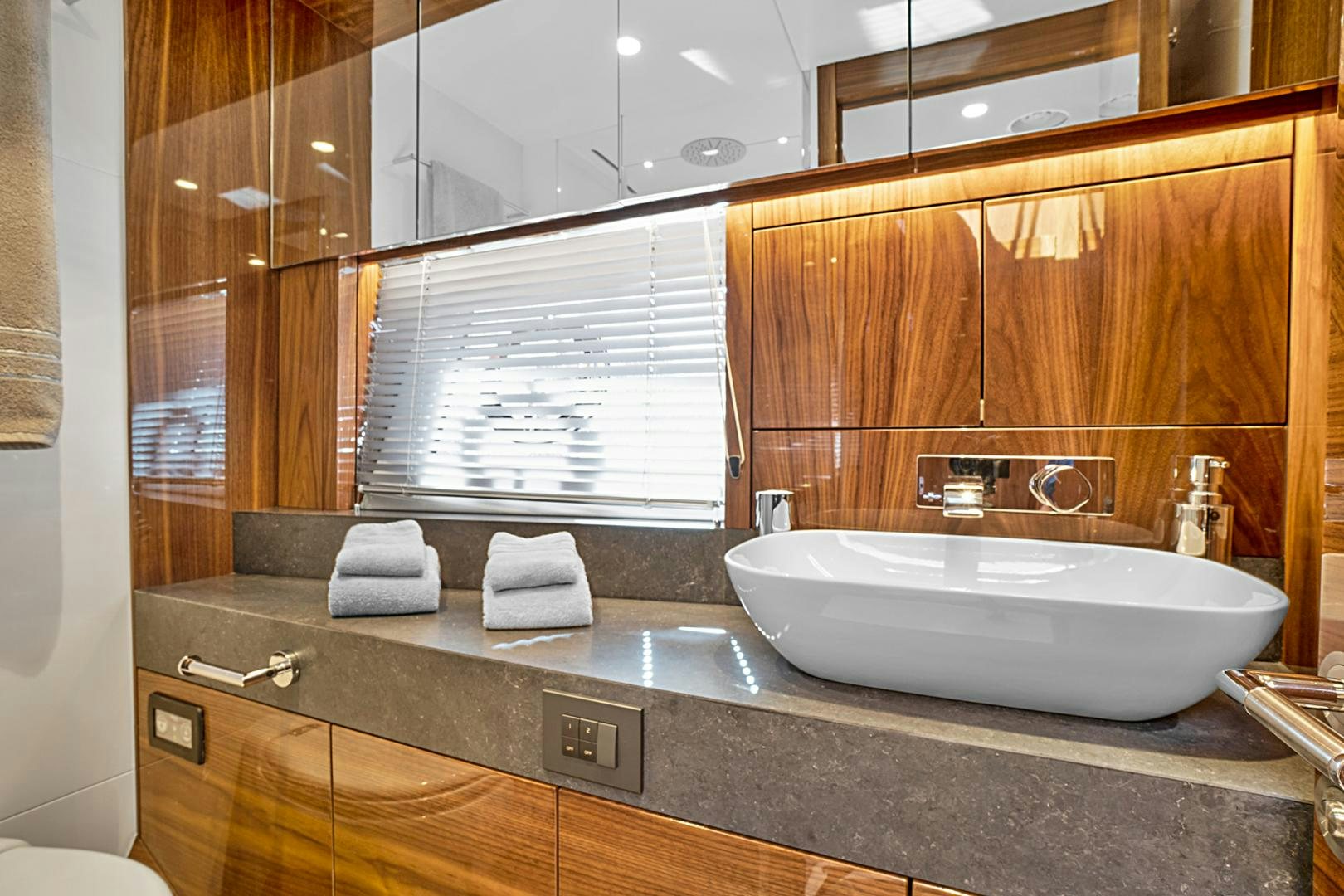 a bathroom with a sink and a mirror aboard YOUNG HEARTS Yacht for Sale