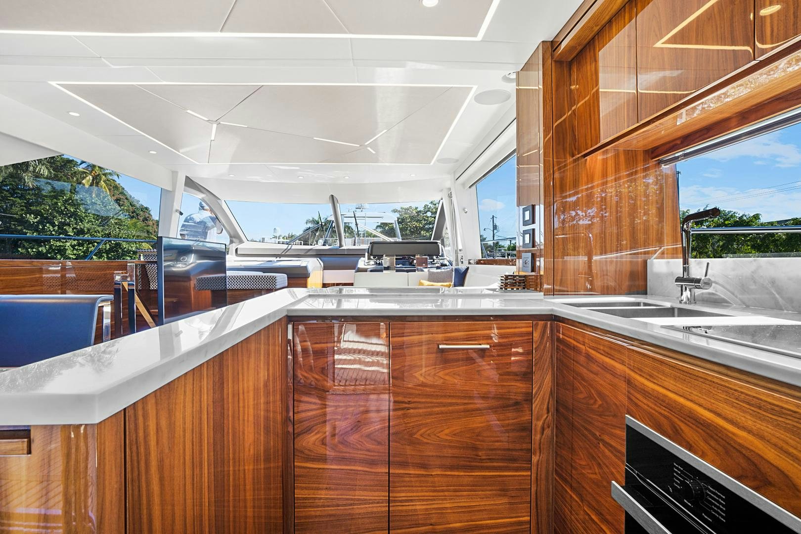 a kitchen with wooden cabinets aboard YOUNG HEARTS Yacht for Sale