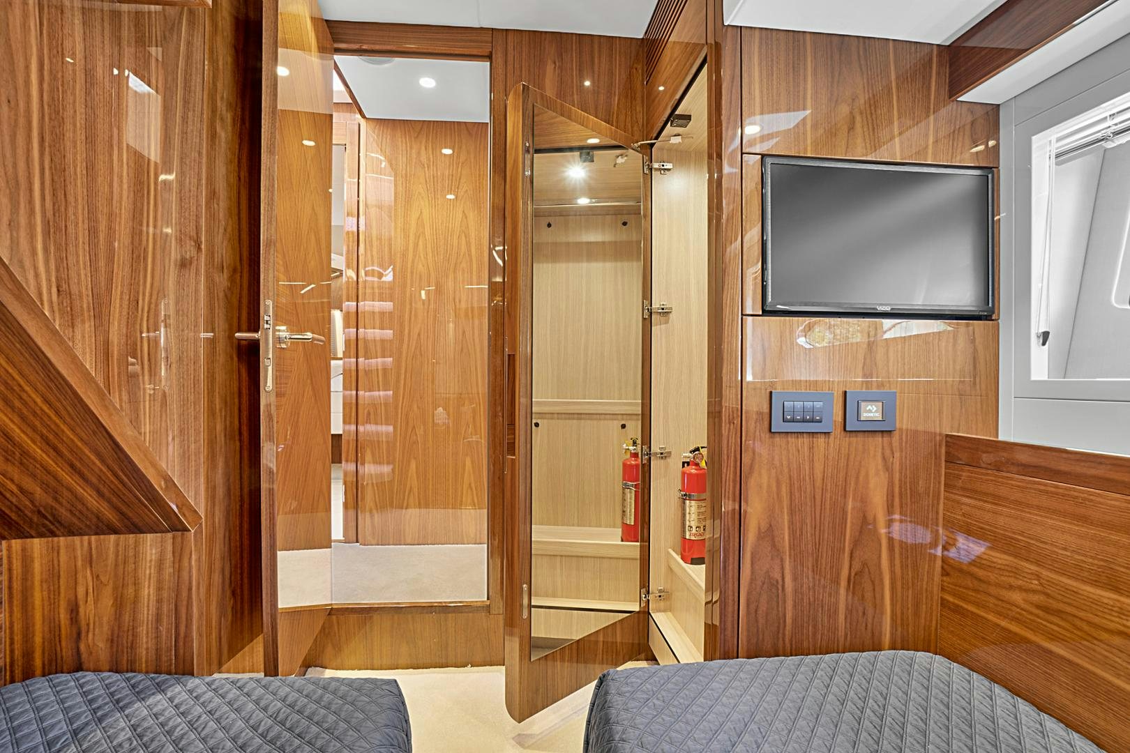 a room with a tv and a bed aboard YOUNG HEARTS Yacht for Sale