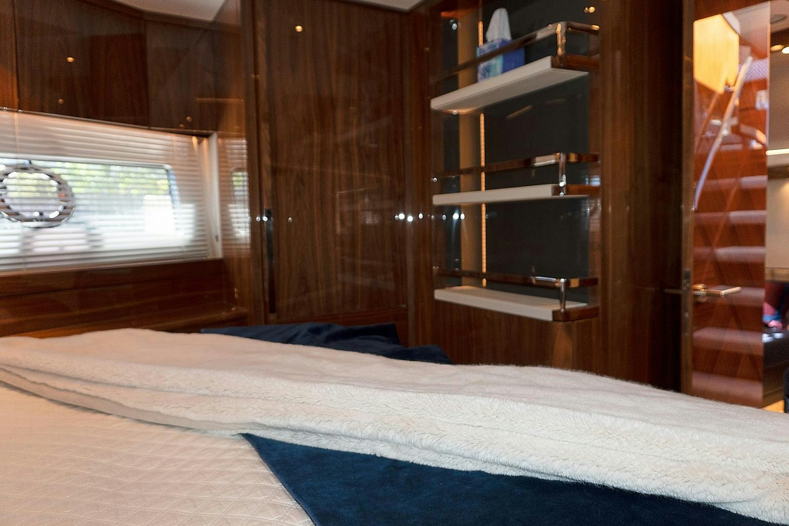a bed with a blue blanket aboard YOUNG HEARTS Yacht for Sale