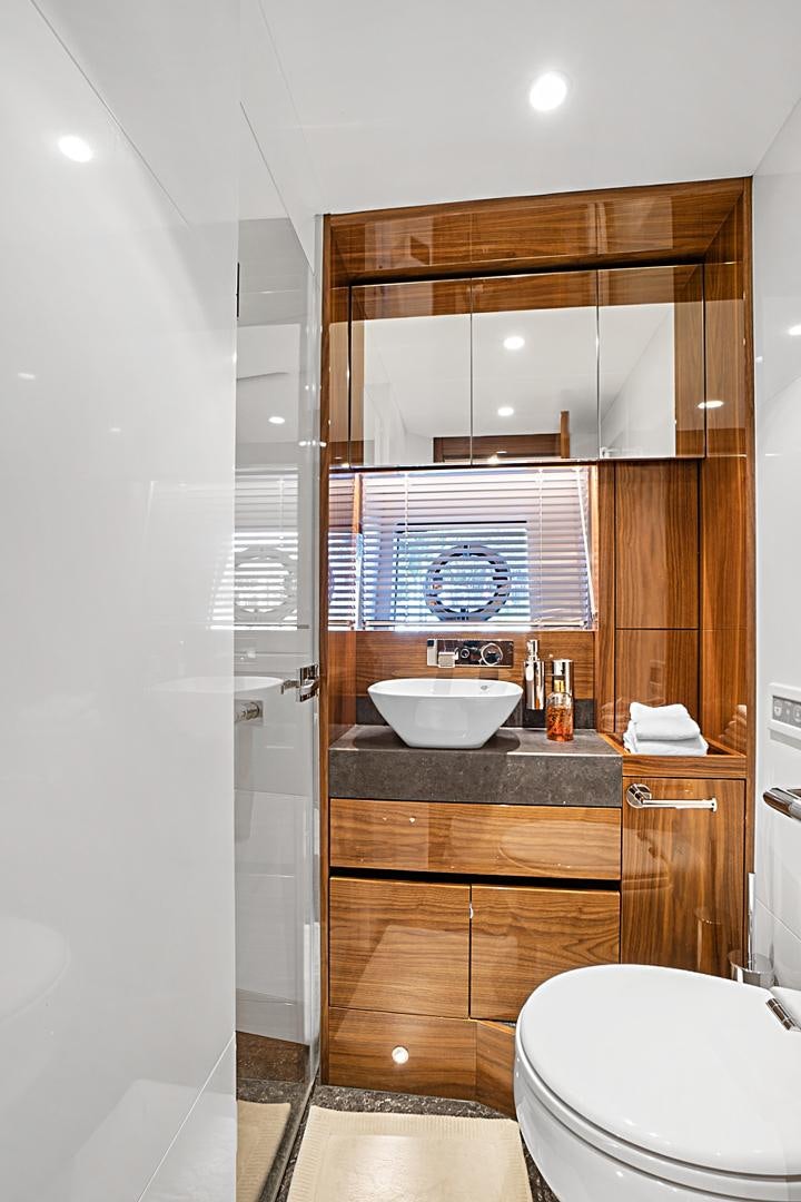 a bathroom with a sink and a mirror aboard YOUNG HEARTS Yacht for Sale