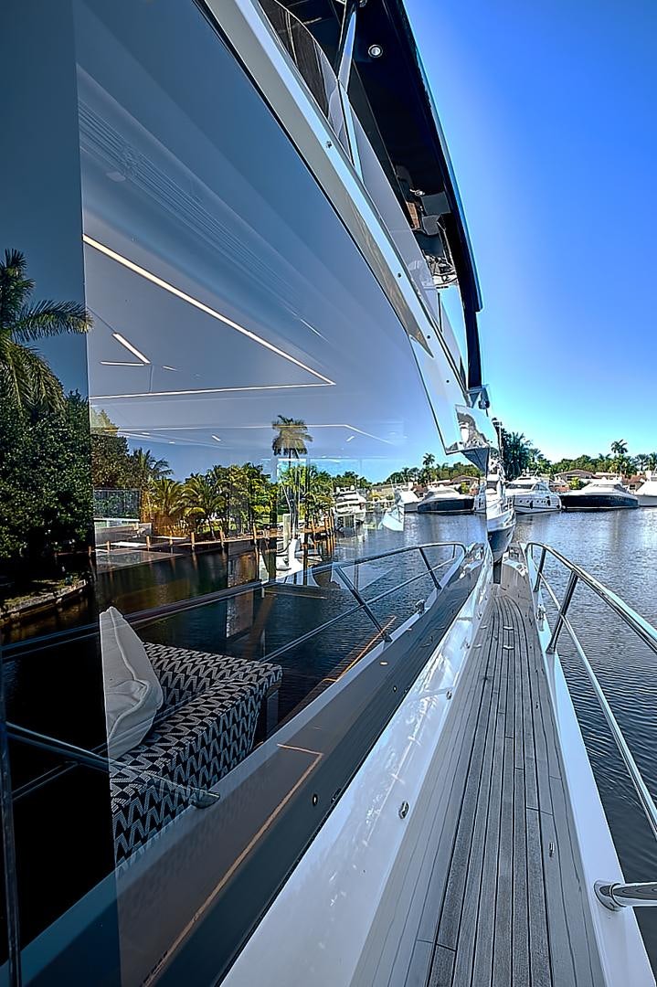 a deck with a view of a city and boats on it aboard YOUNG HEARTS Yacht for Sale
