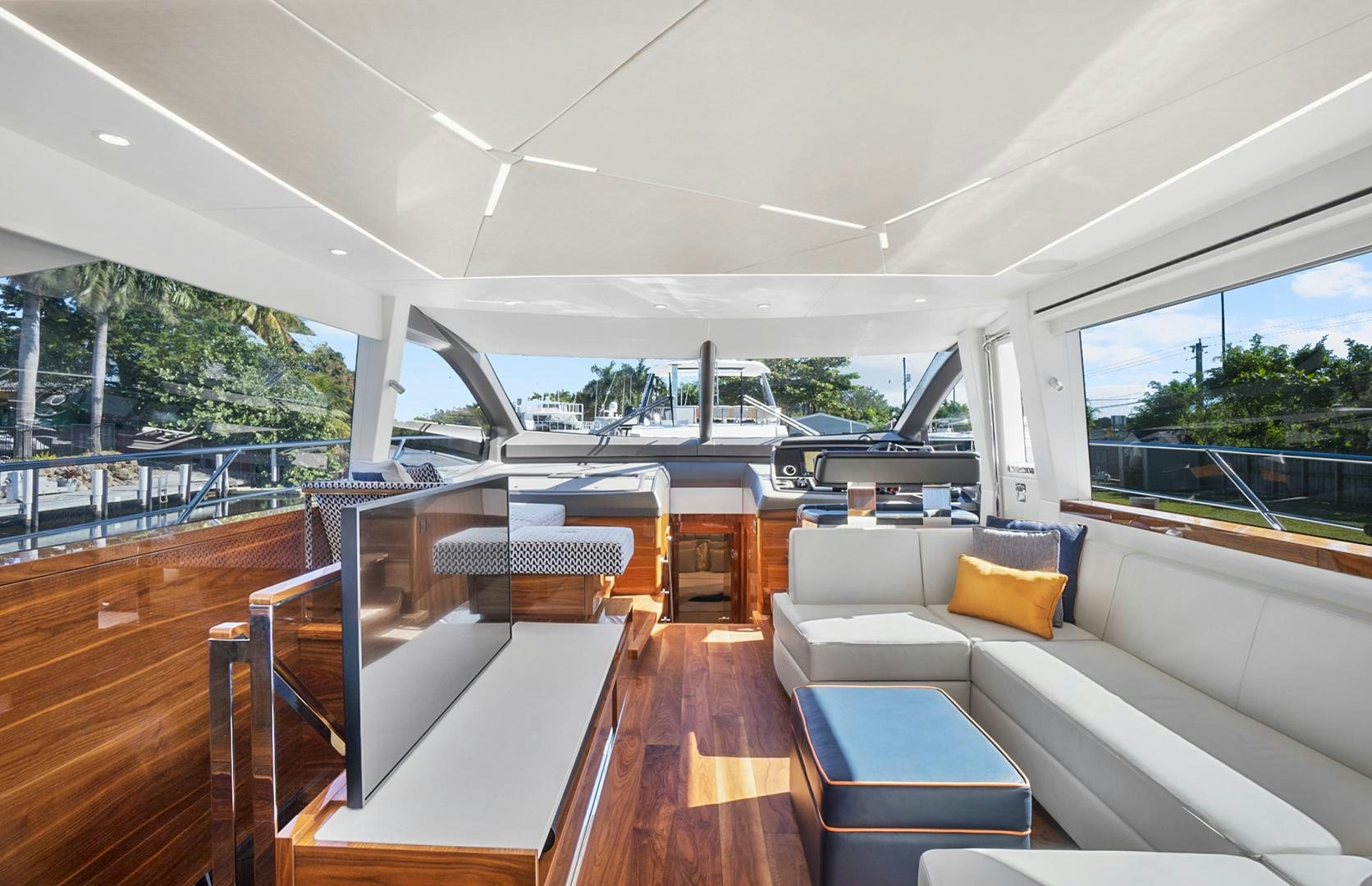 a large living room with a wood floor and a large window aboard YOUNG HEARTS Yacht for Sale