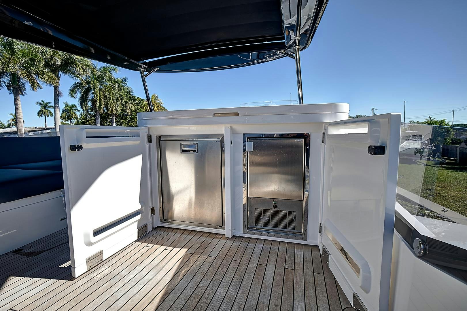 a deck with a couple of large doors and a pool aboard YOUNG HEARTS Yacht for Sale