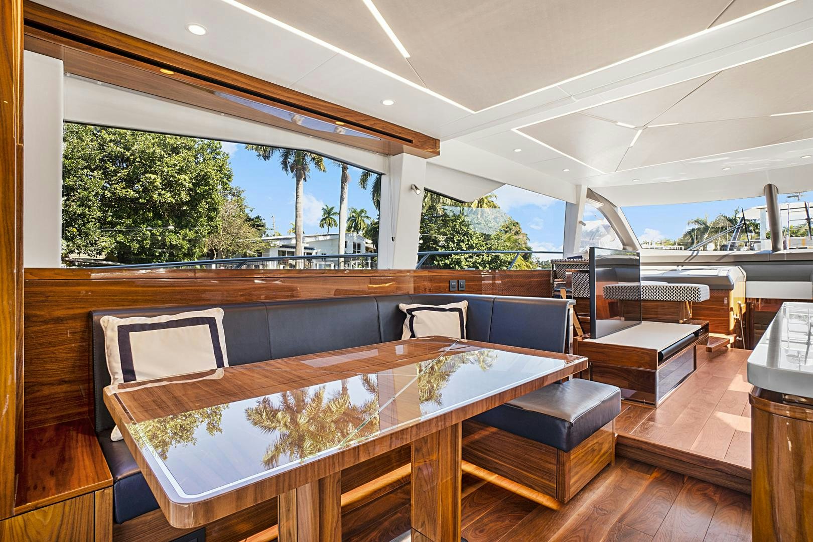 a large room with a table and chairs aboard YOUNG HEARTS Yacht for Sale