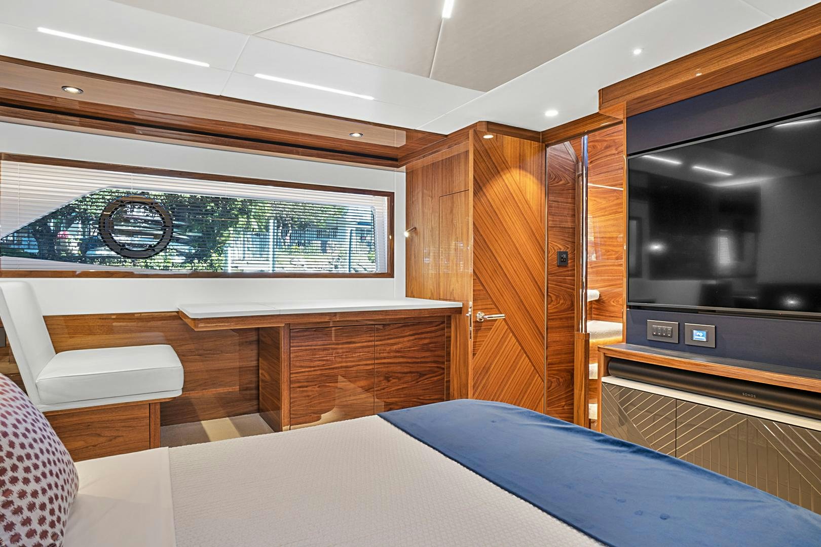 a room with a bed and a television aboard YOUNG HEARTS Yacht for Sale