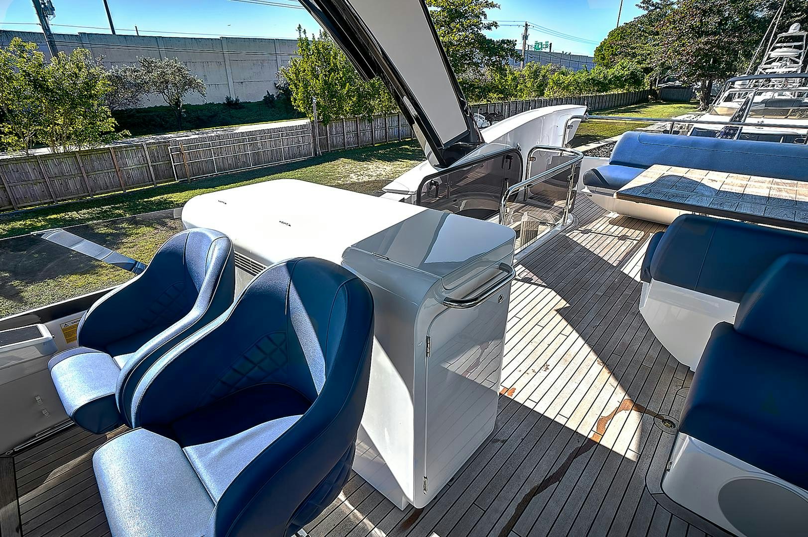 a deck with chairs and a table on it aboard YOUNG HEARTS Yacht for Sale