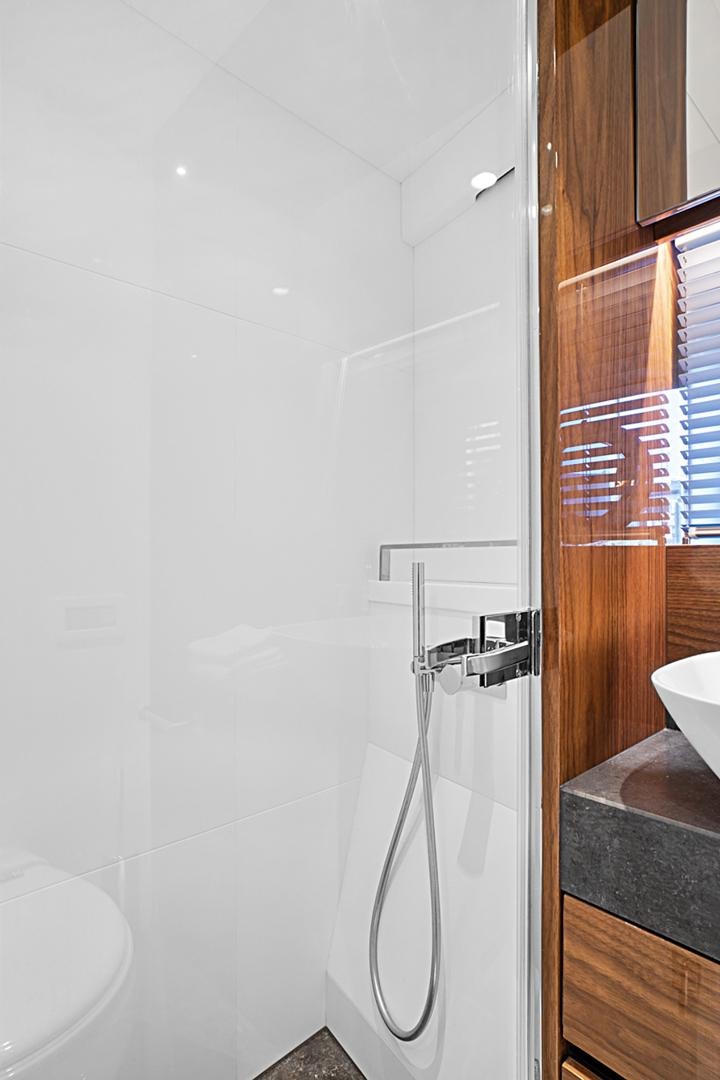 a shower with a sink and a mirror aboard YOUNG HEARTS Yacht for Sale