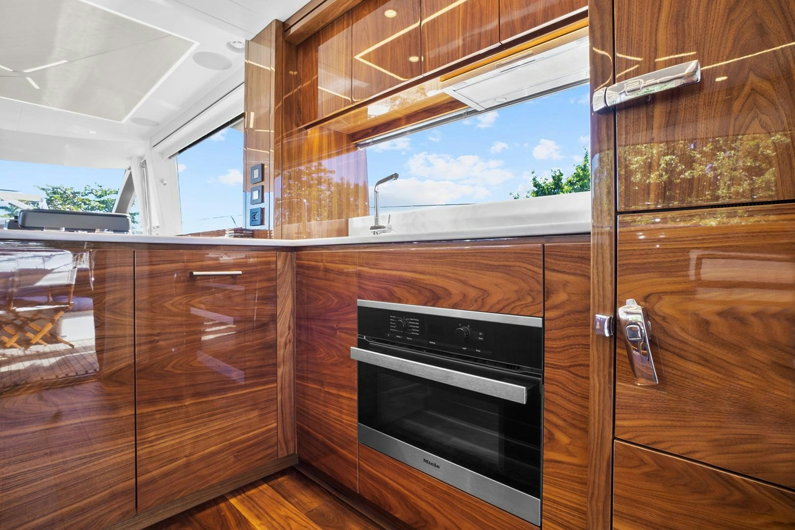 a kitchen with wooden cabinets aboard YOUNG HEARTS Yacht for Sale
