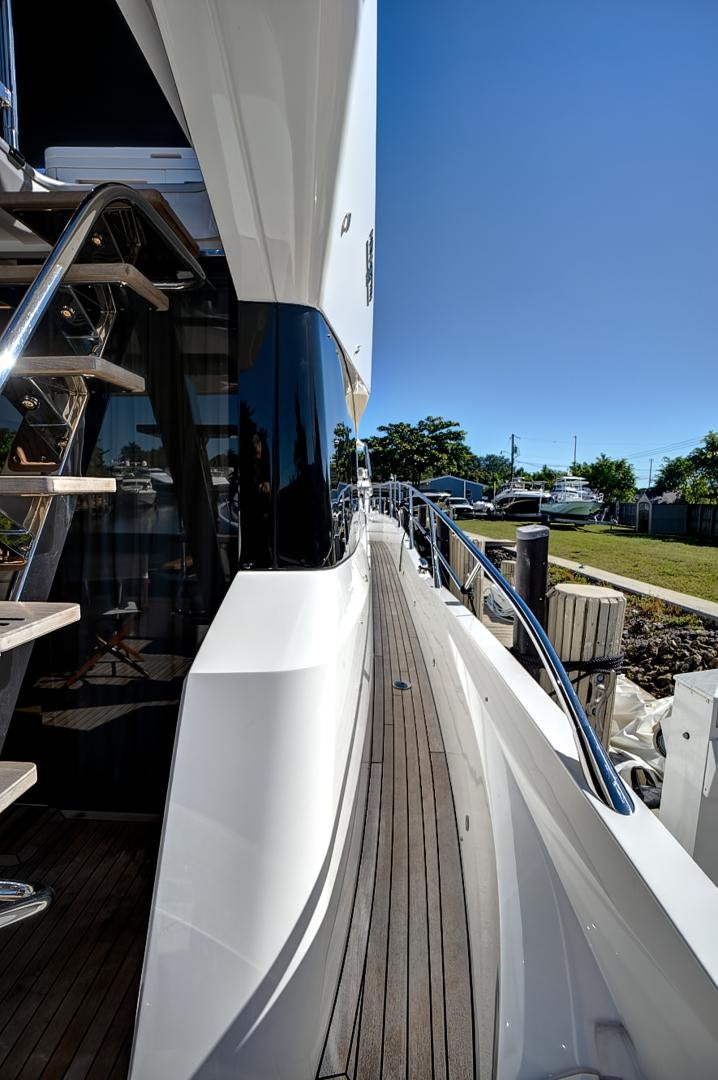 a deck with a large white railing aboard YOUNG HEARTS Yacht for Sale