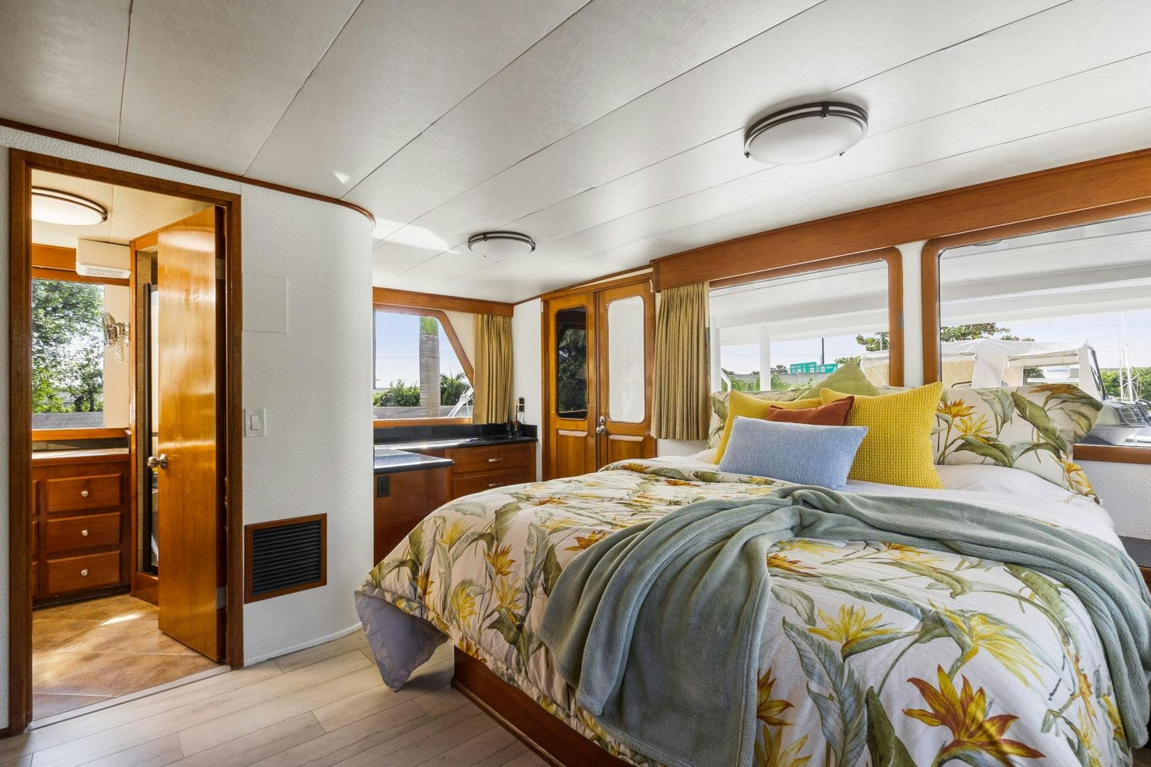 a bedroom with a bed and a door aboard MOVIE SET Yacht for Sale