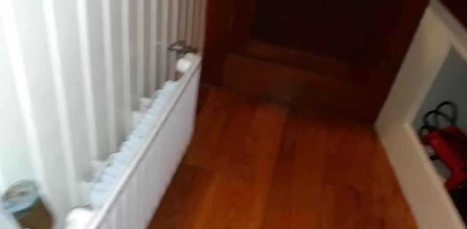 a room with a wood floor and white curtains aboard WANDERBIRD Yacht for Sale