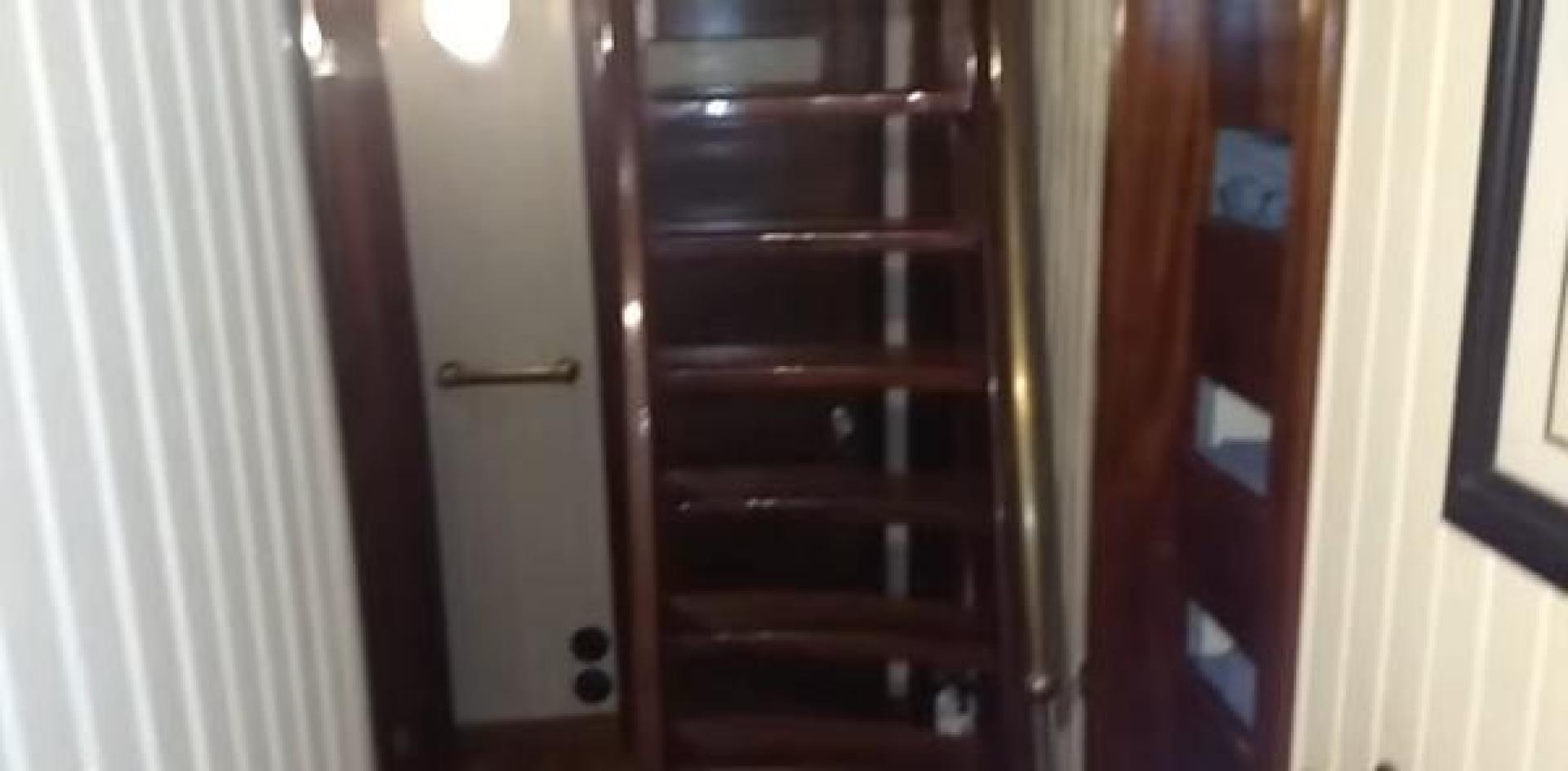 a wooden cabinet with a door aboard WANDERBIRD Yacht for Sale