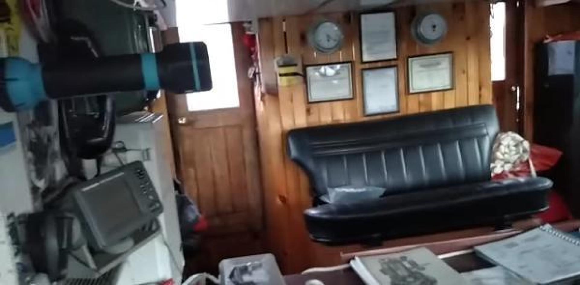 a room with a television and a desk aboard WANDERBIRD Yacht for Sale