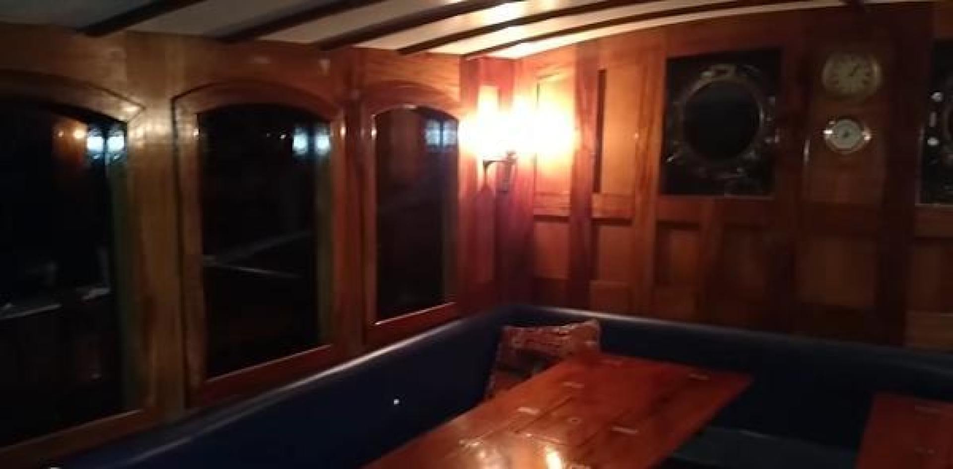 a room with a table and a clock aboard WANDERBIRD Yacht for Sale