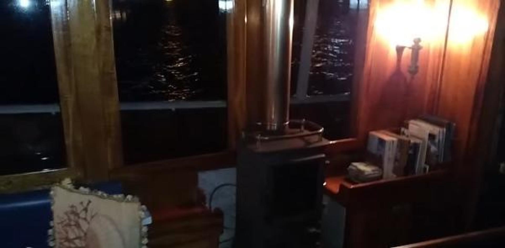 a room with a lamp and bookshelf aboard WANDERBIRD Yacht for Sale