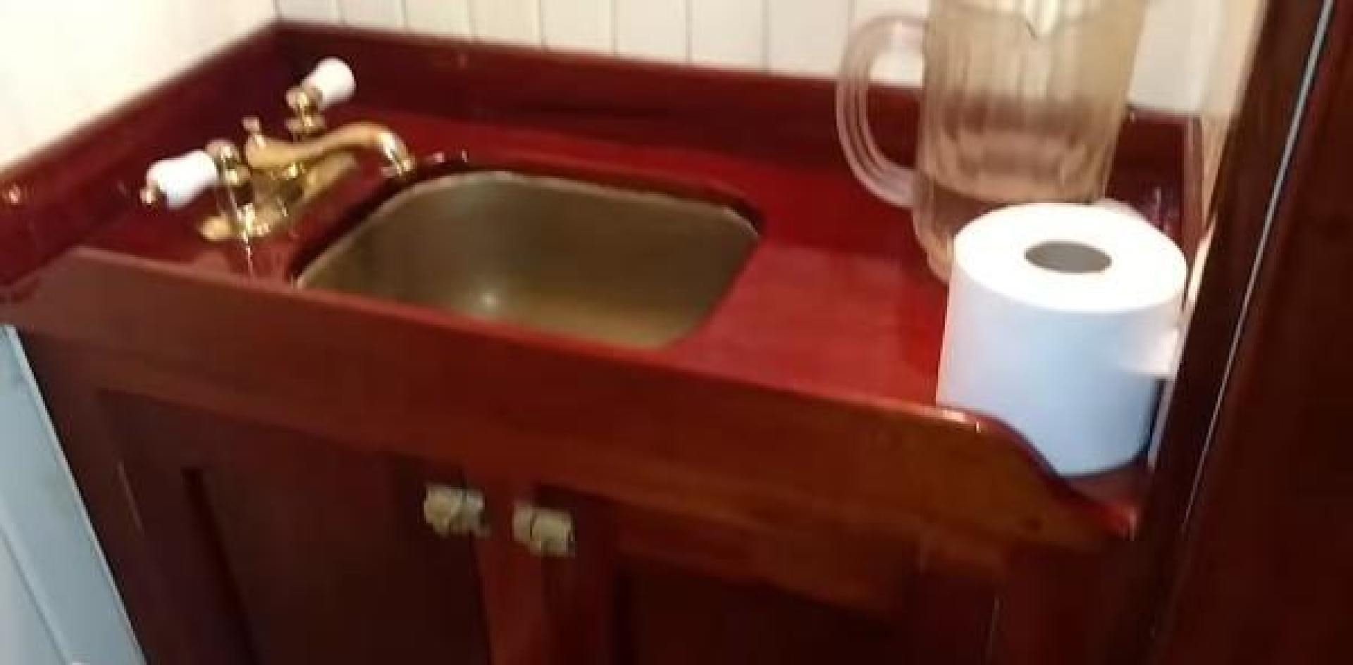 a sink with a faucet and a soap dispenser aboard WANDERBIRD Yacht for Sale