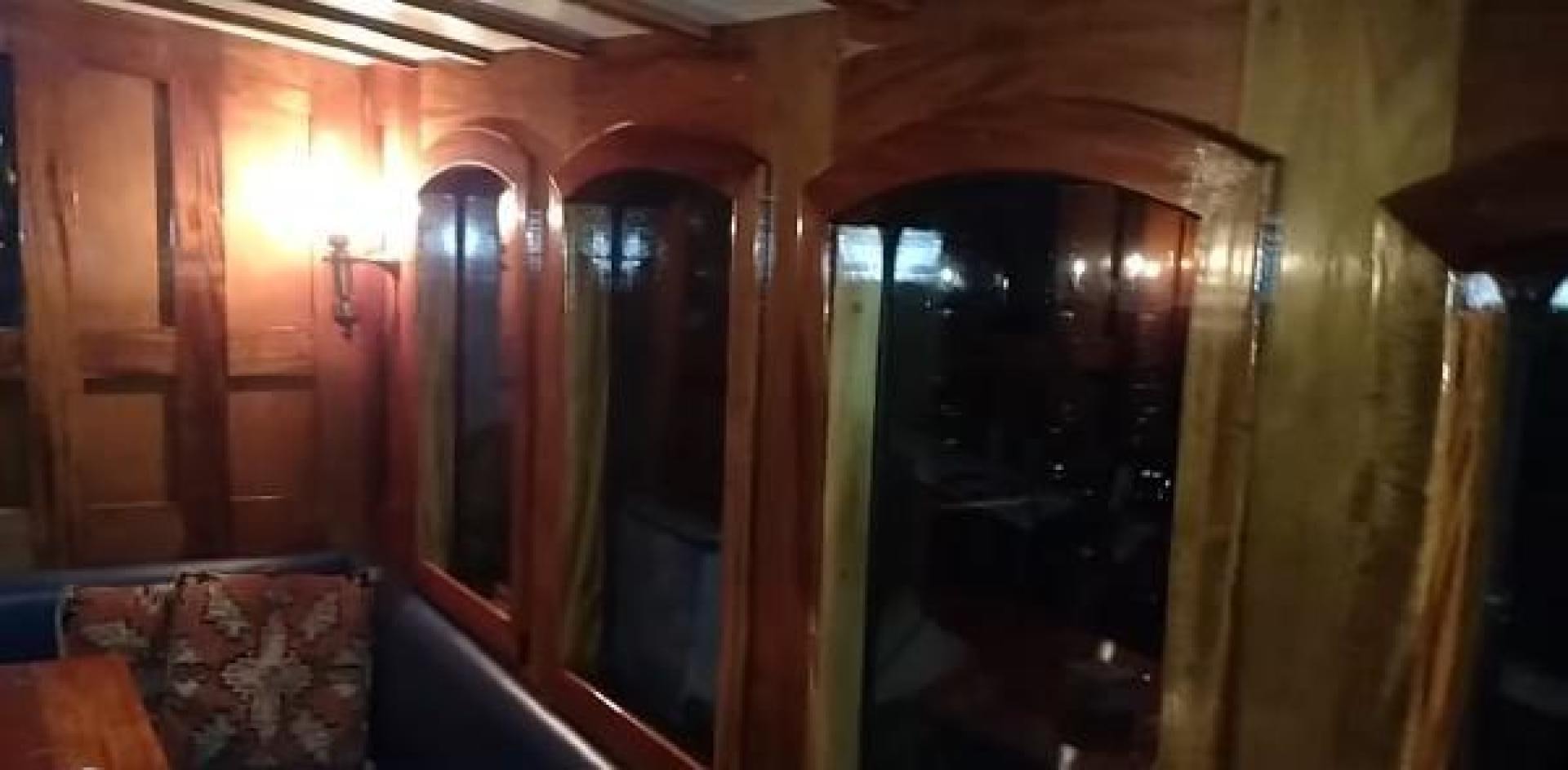 a room with a couch and a mirror aboard WANDERBIRD Yacht for Sale