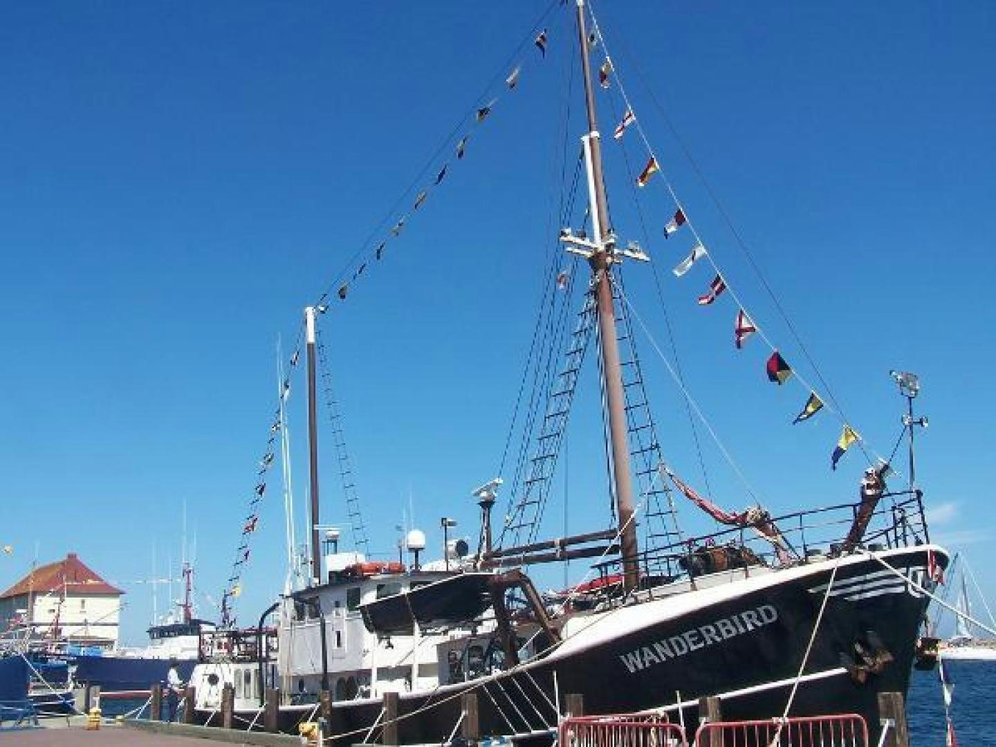 a boat docked at a pier aboard WANDERBIRD Yacht for Sale