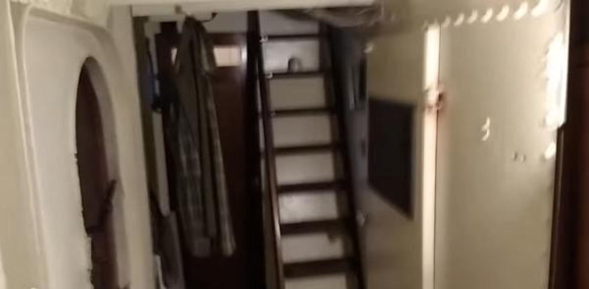 a closet with clothes on the wall aboard WANDERBIRD Yacht for Sale