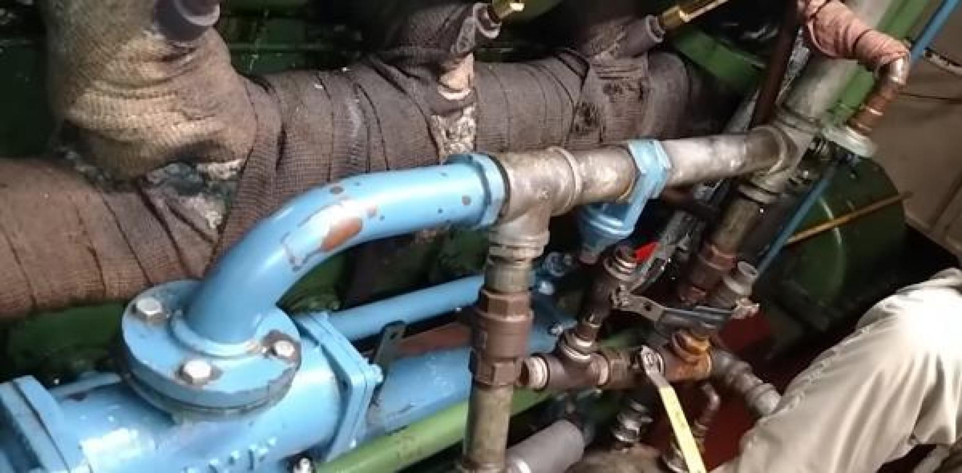 a man working on a machine aboard WANDERBIRD Yacht for Sale
