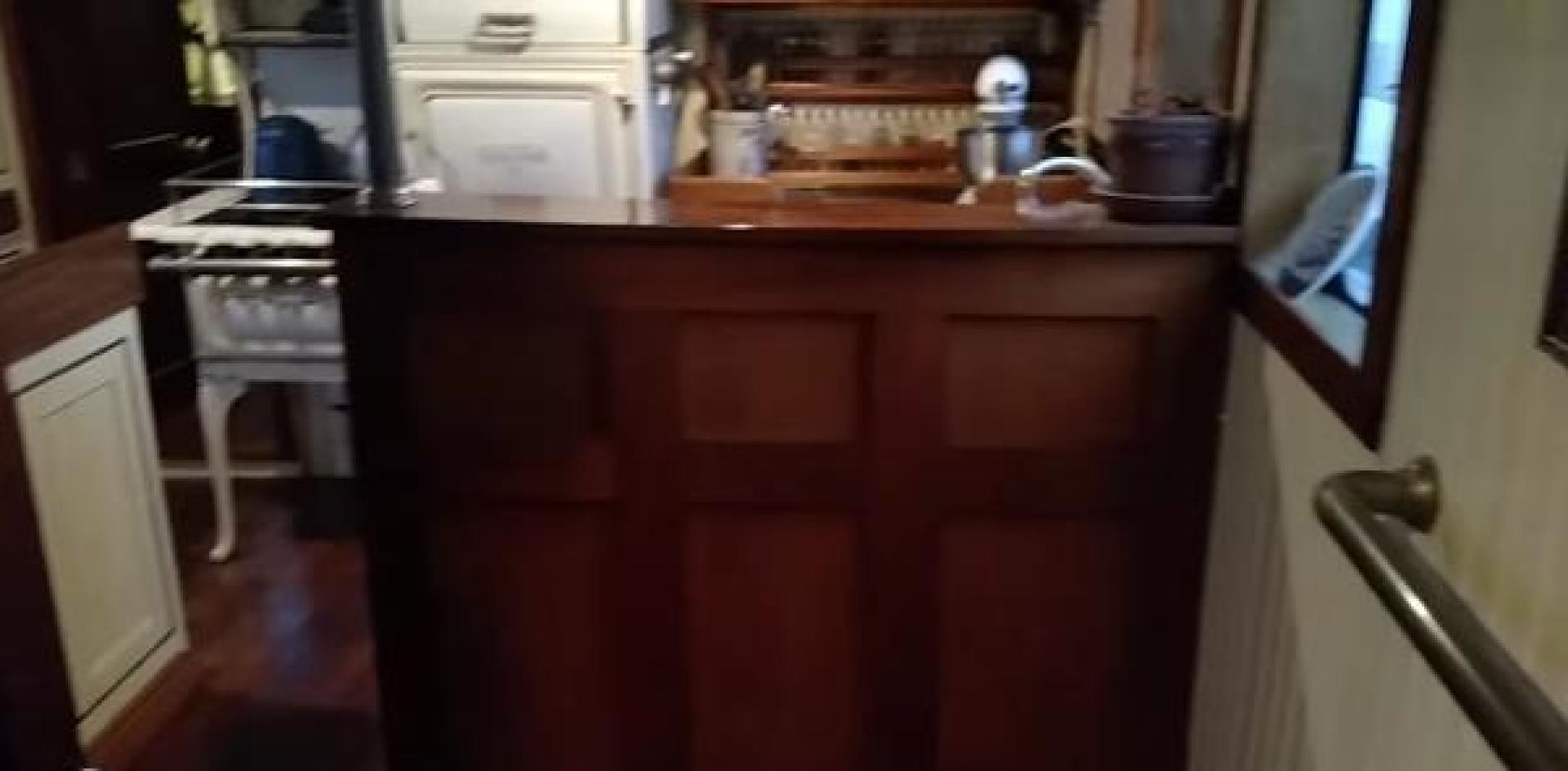 a kitchen with a microwave oven and a wooden counter aboard WANDERBIRD Yacht for Sale