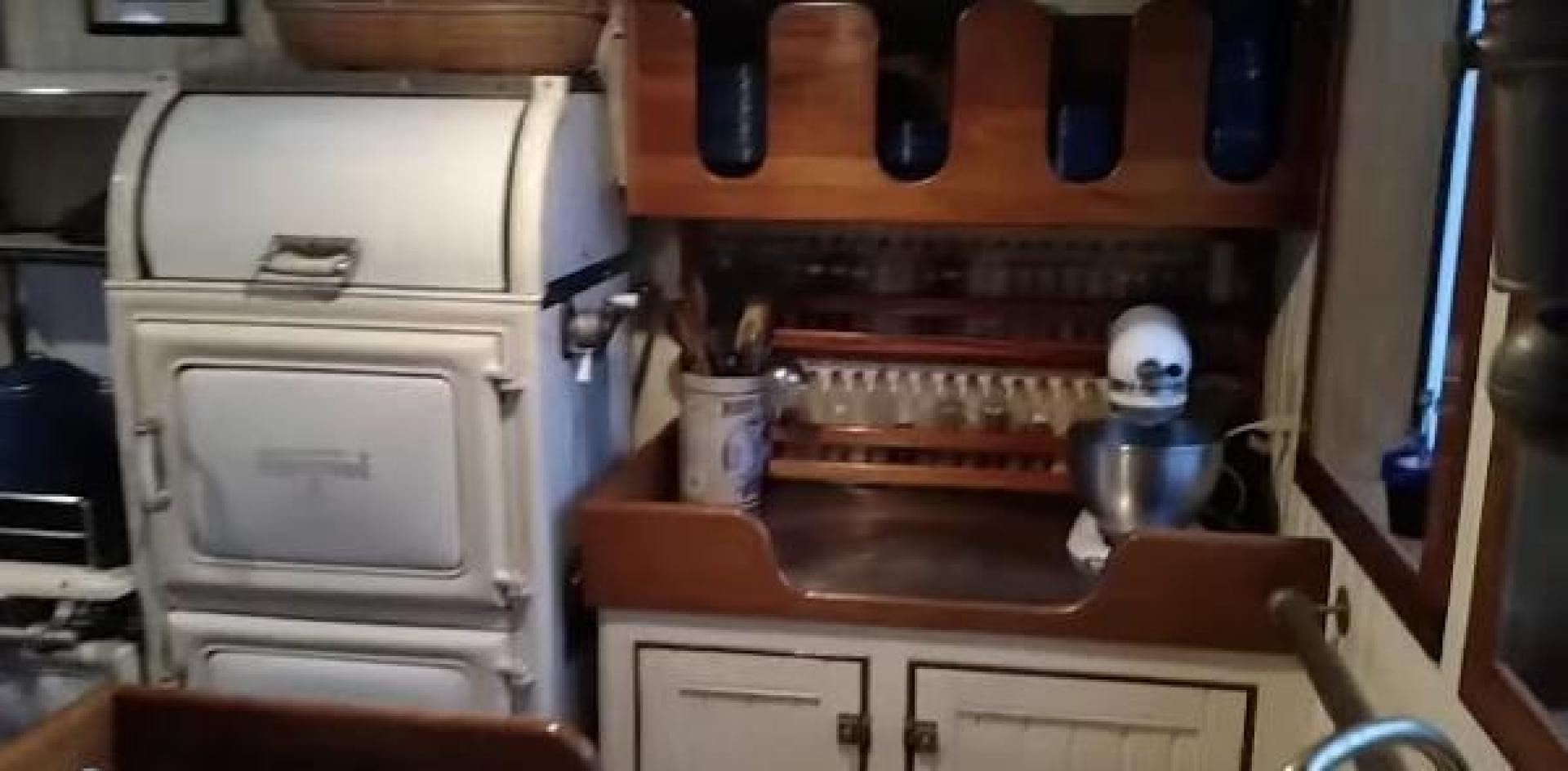 a kitchen with a stove and a microwave aboard WANDERBIRD Yacht for Sale