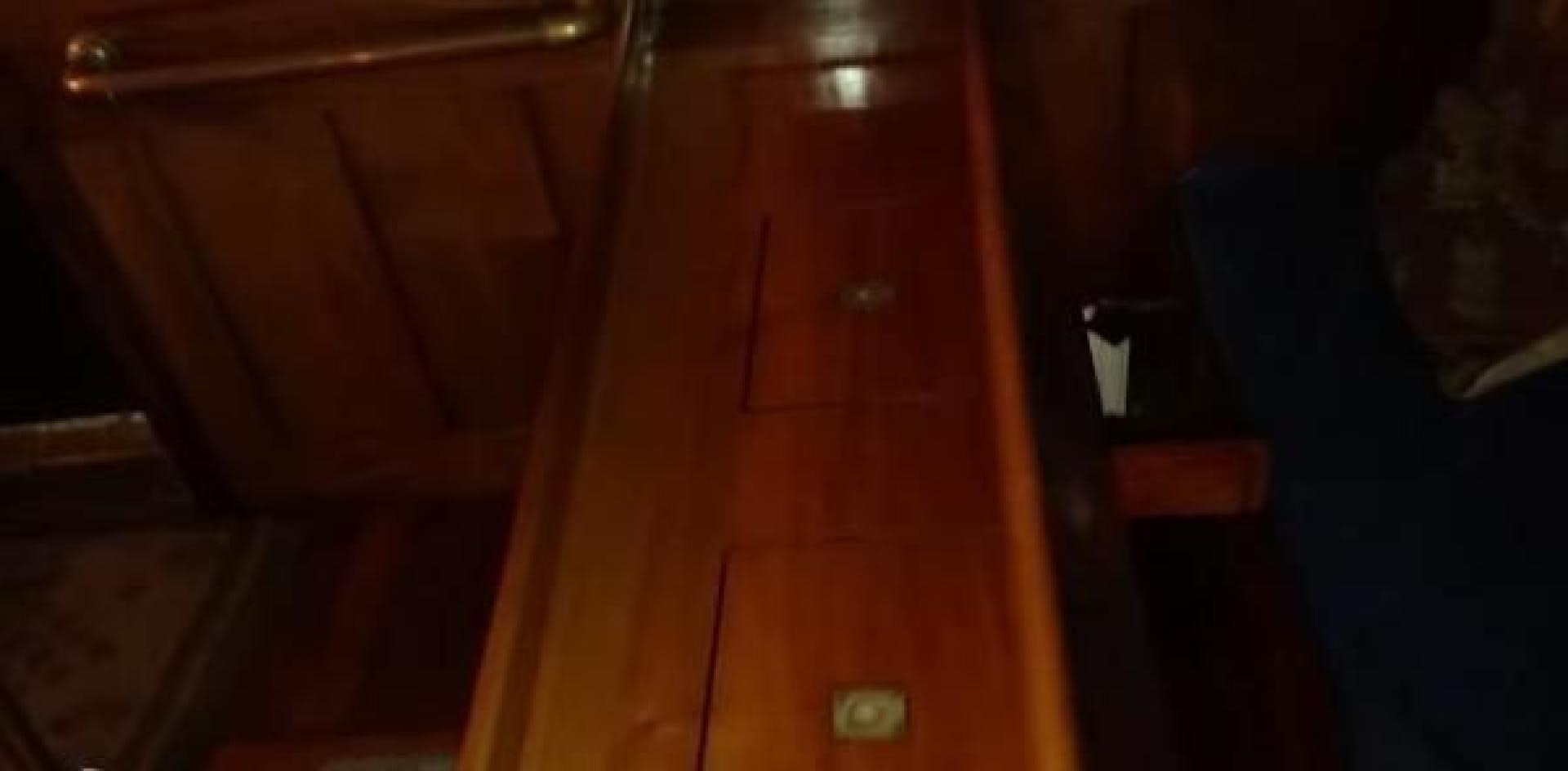 a wooden cabinet with a door aboard WANDERBIRD Yacht for Sale