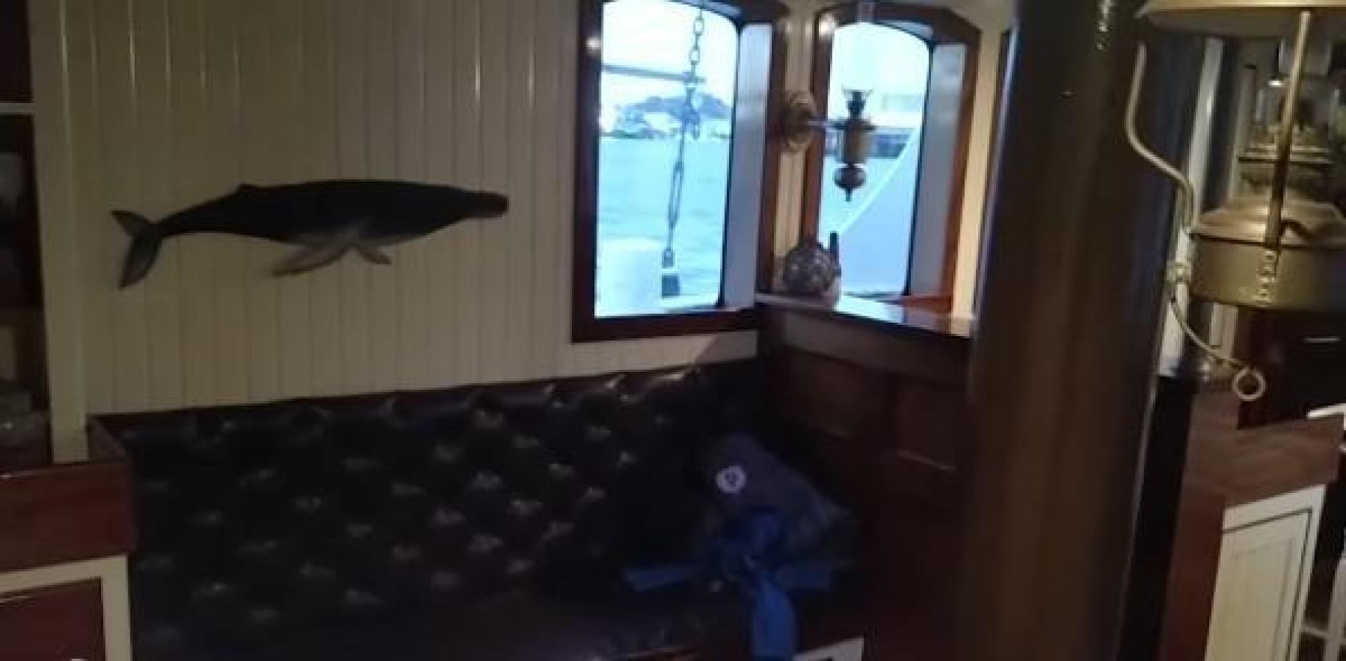 a room with a bed and a window aboard WANDERBIRD Yacht for Sale