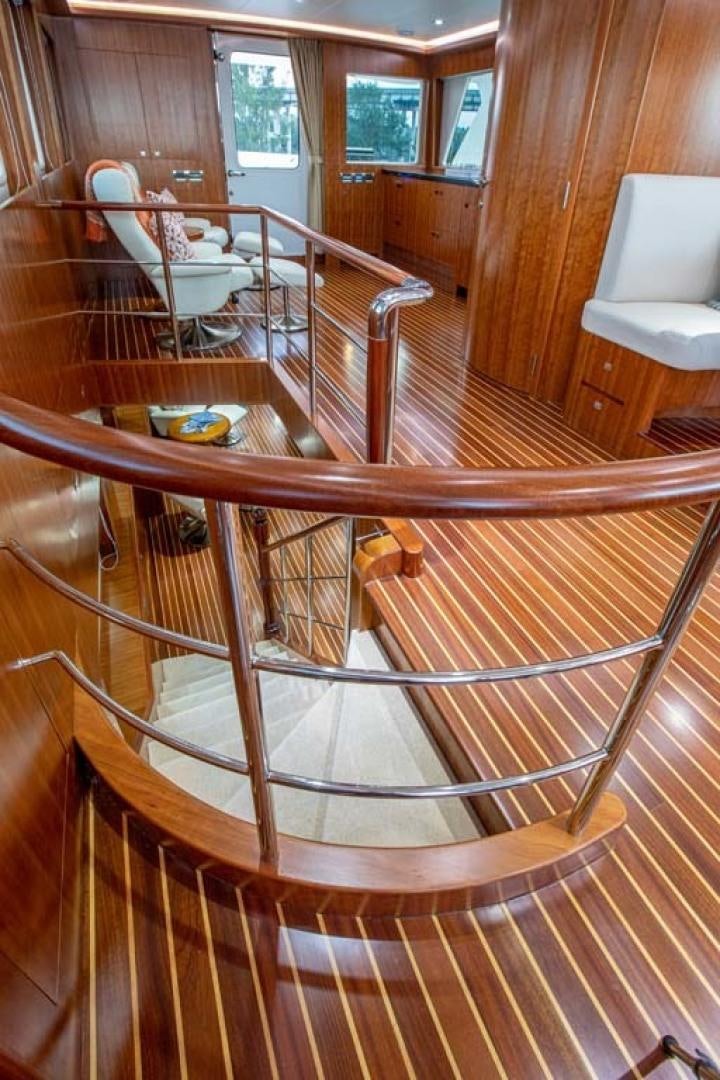 a wooden staircase with a railing aboard LORETTA Yacht for Sale