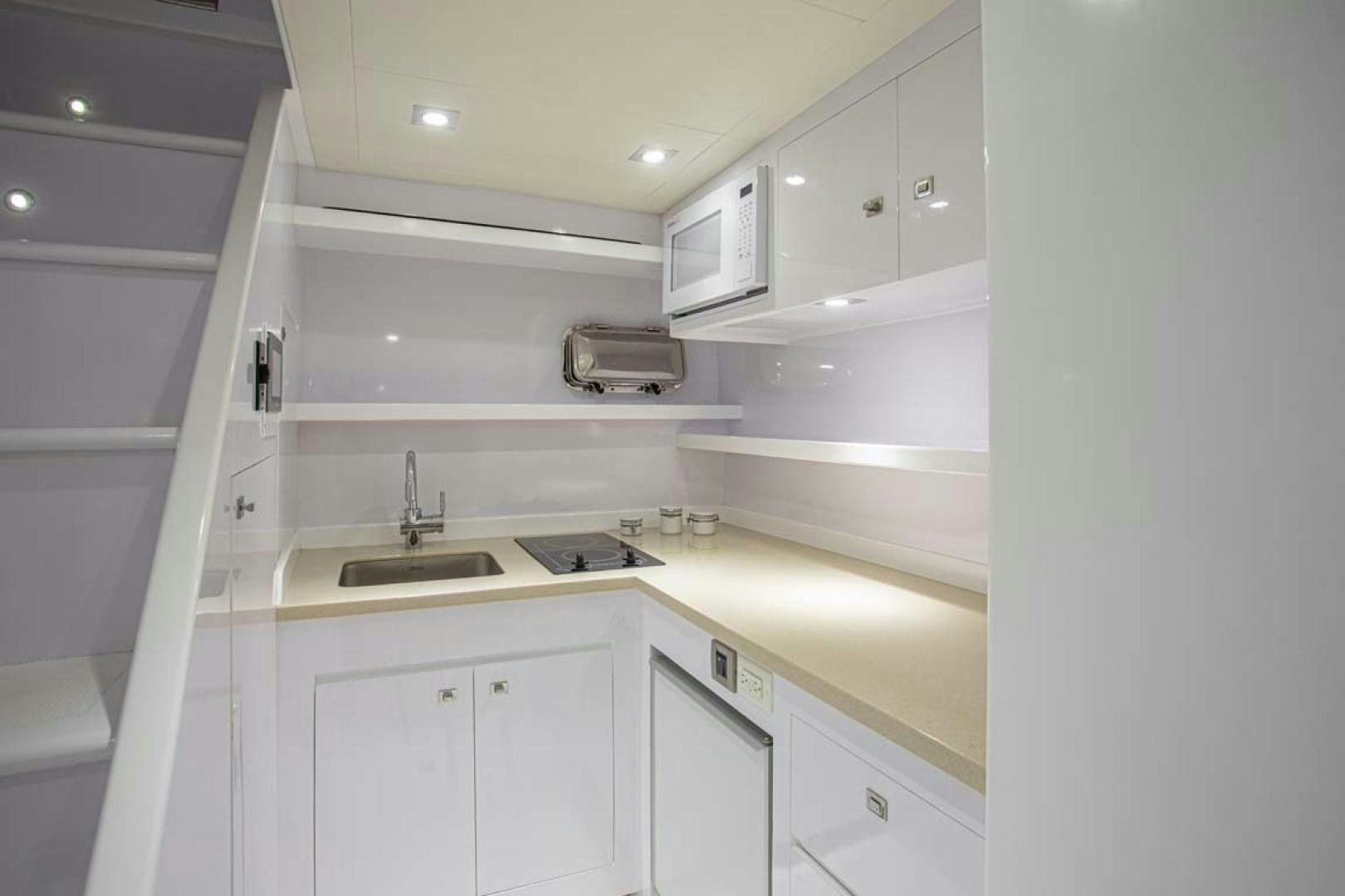 a white kitchen with white cabinets aboard LORETTA Yacht for Sale