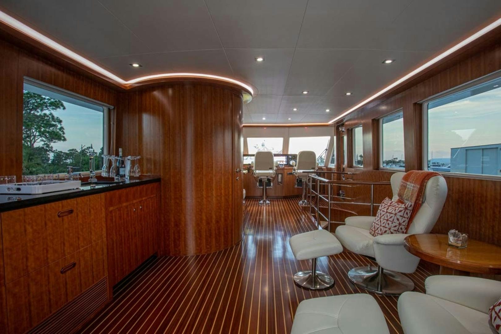 a large room with a wood paneled wall and a wood door aboard LORETTA Yacht for Sale