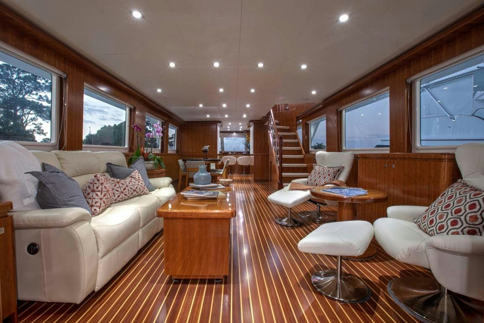 a living room with a wood floor aboard LORETTA Yacht for Sale