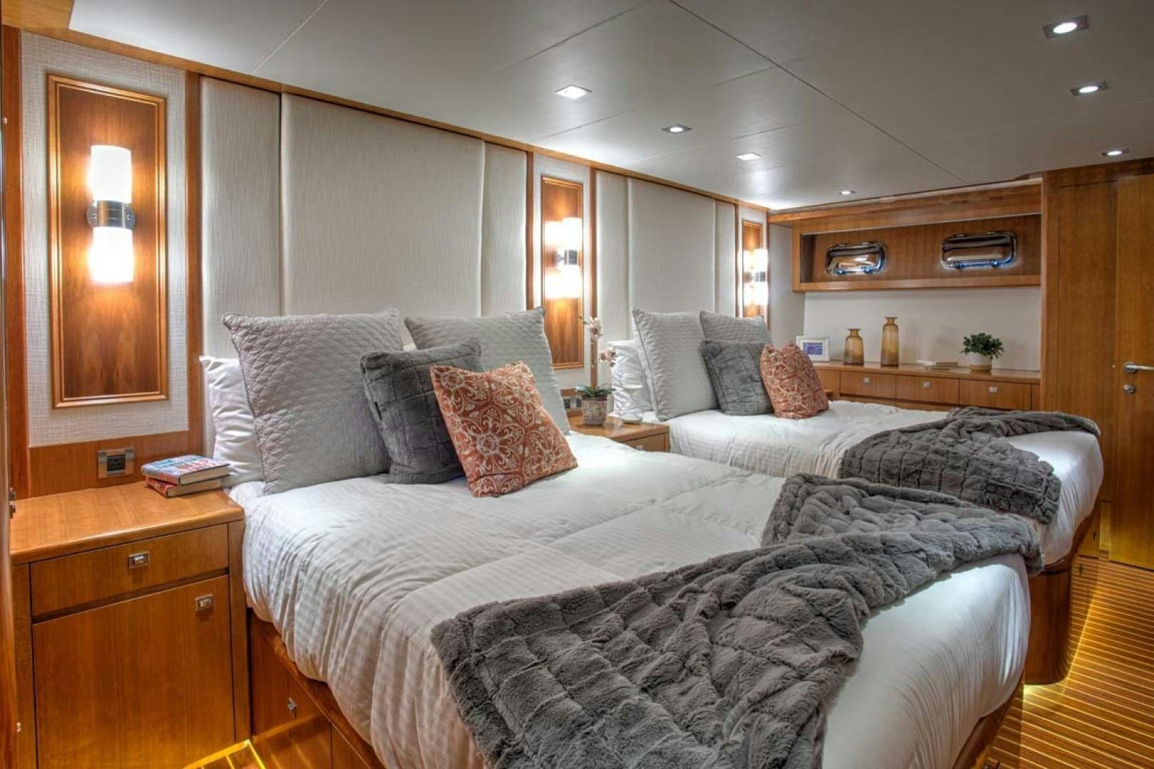 a bedroom with a bed and a mirror aboard LORETTA Yacht for Sale