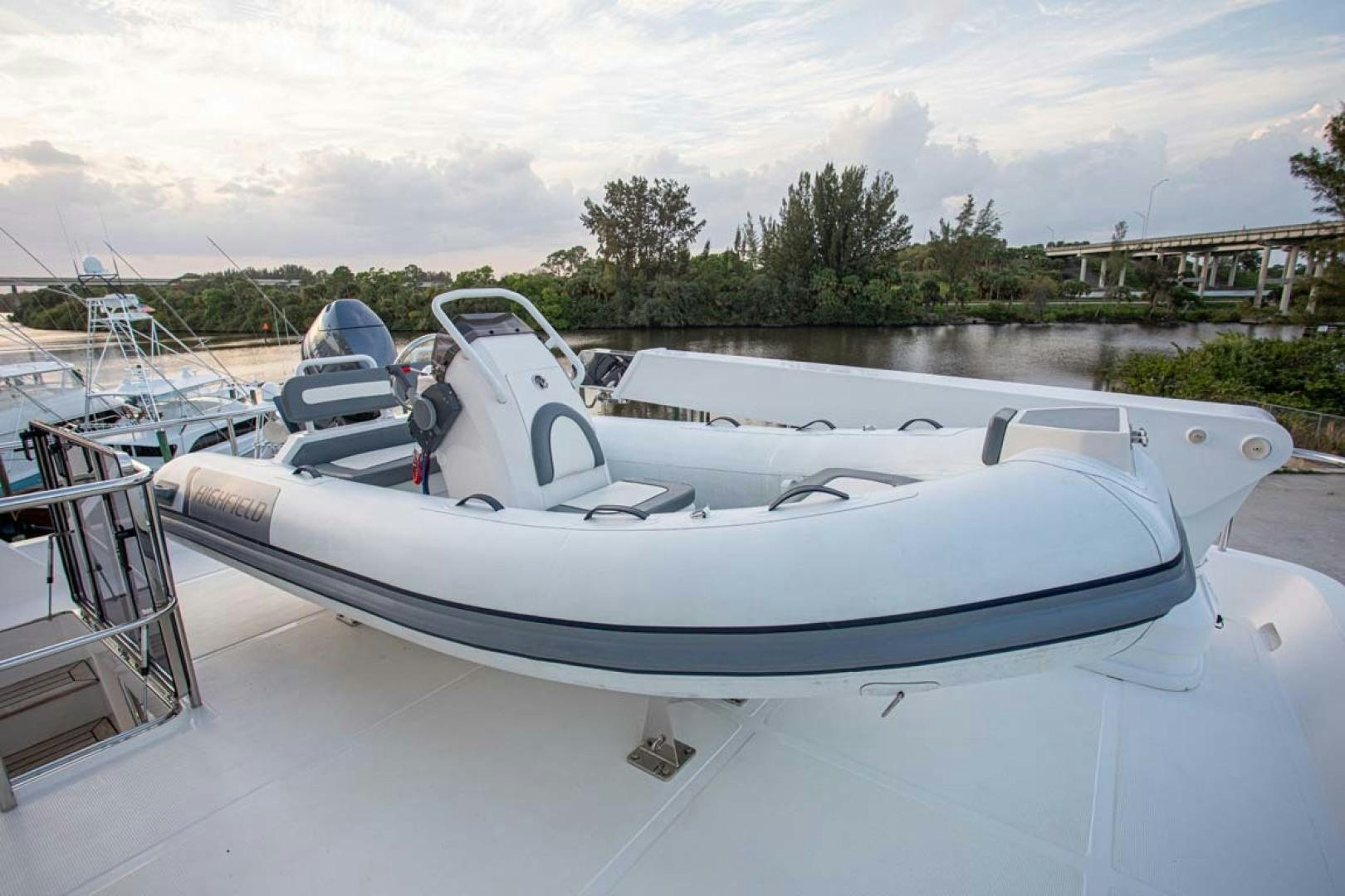 a white boat in a harbor aboard LORETTA Yacht for Sale
