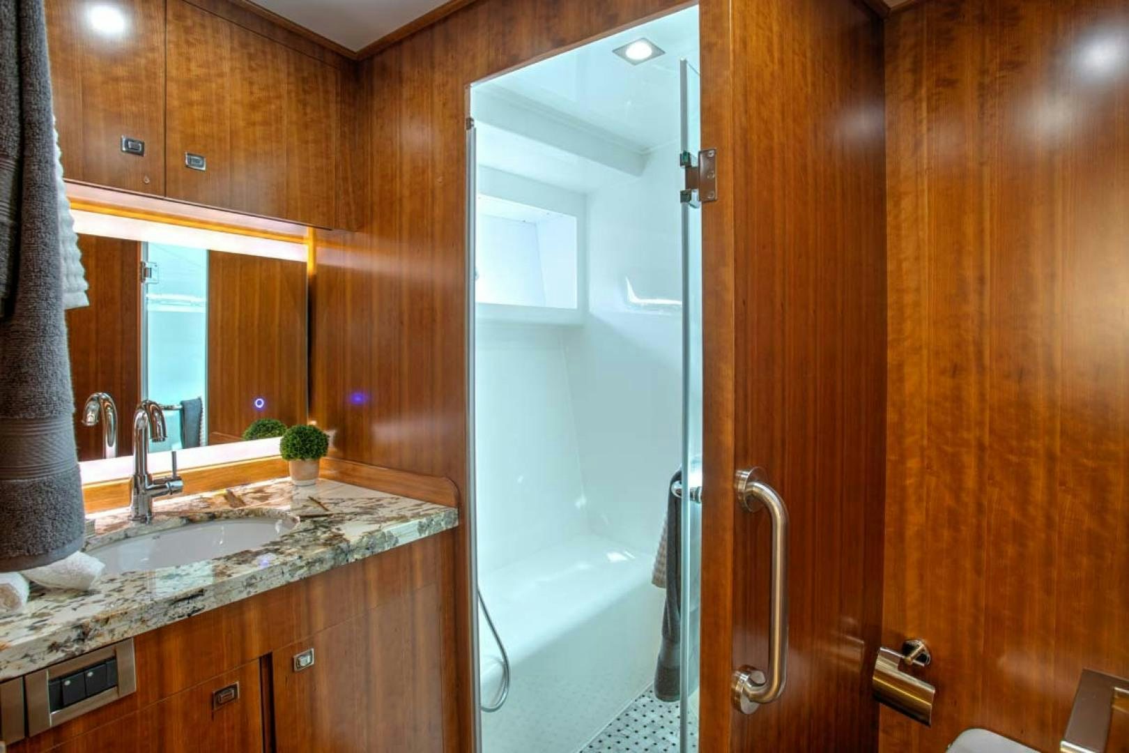 a bathroom with a glass shower aboard LORETTA Yacht for Sale