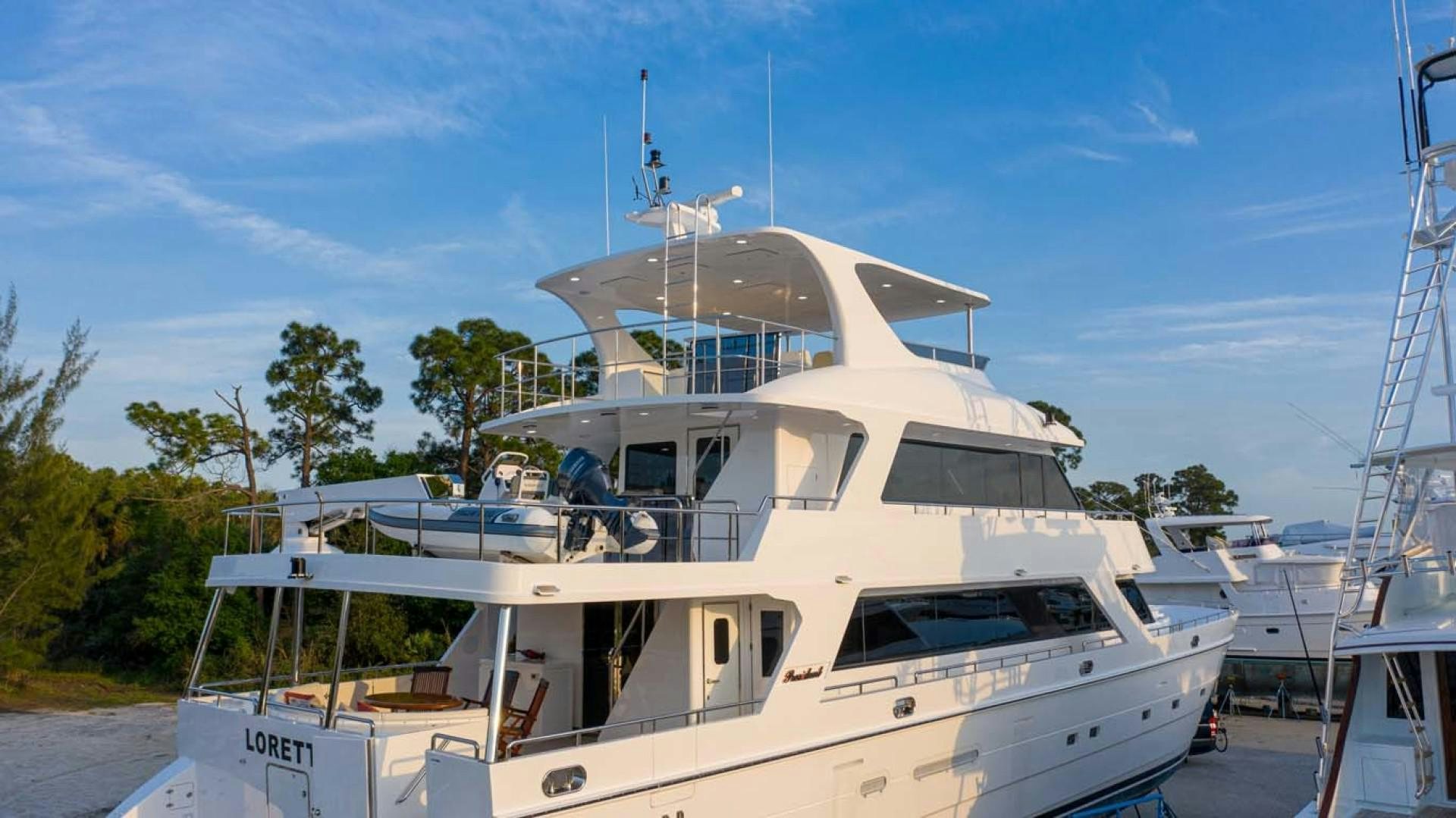 a white boat in a harbor aboard LORETTA Yacht for Sale