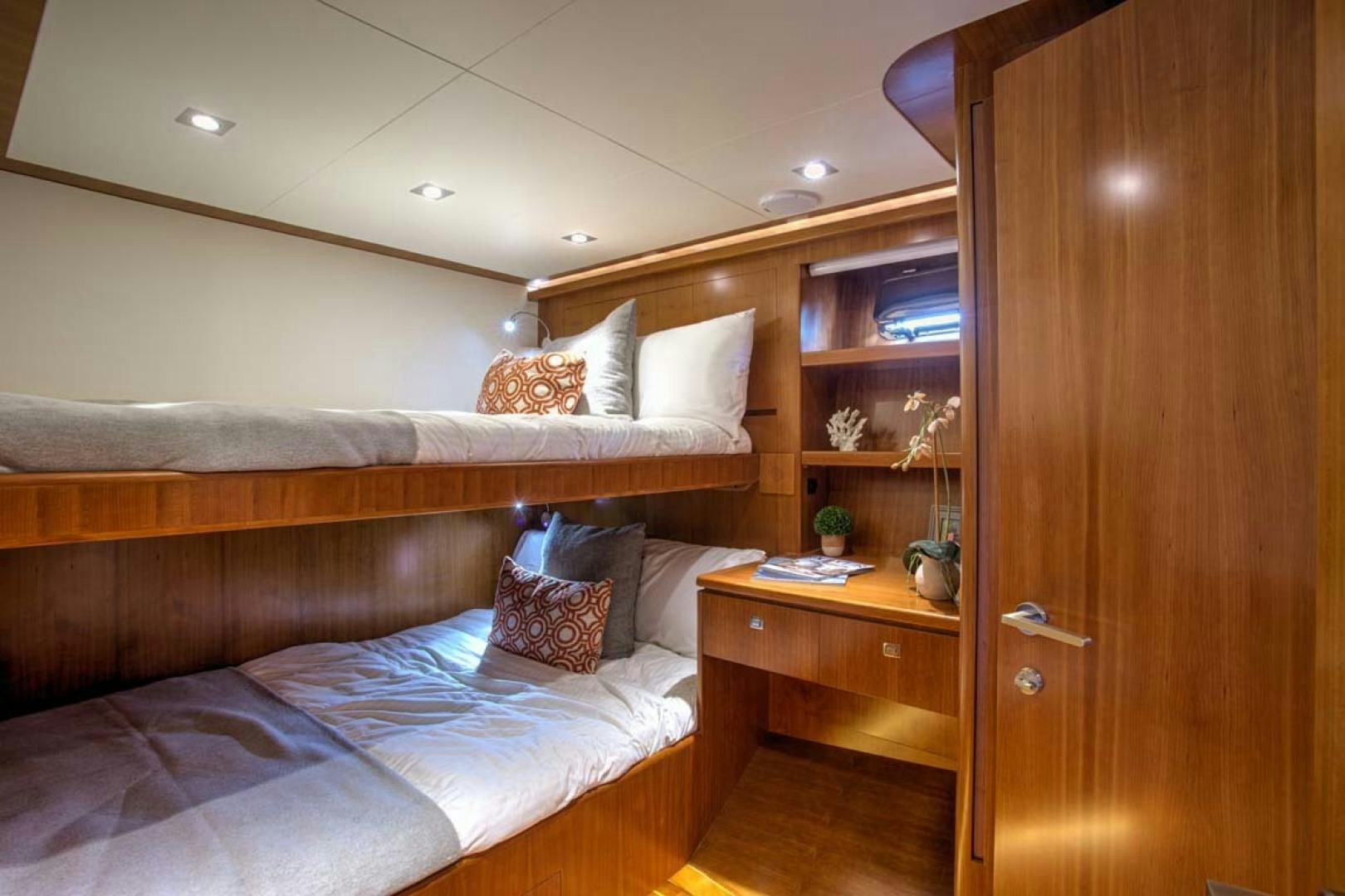 a bedroom with a bed and a desk aboard LORETTA Yacht for Sale