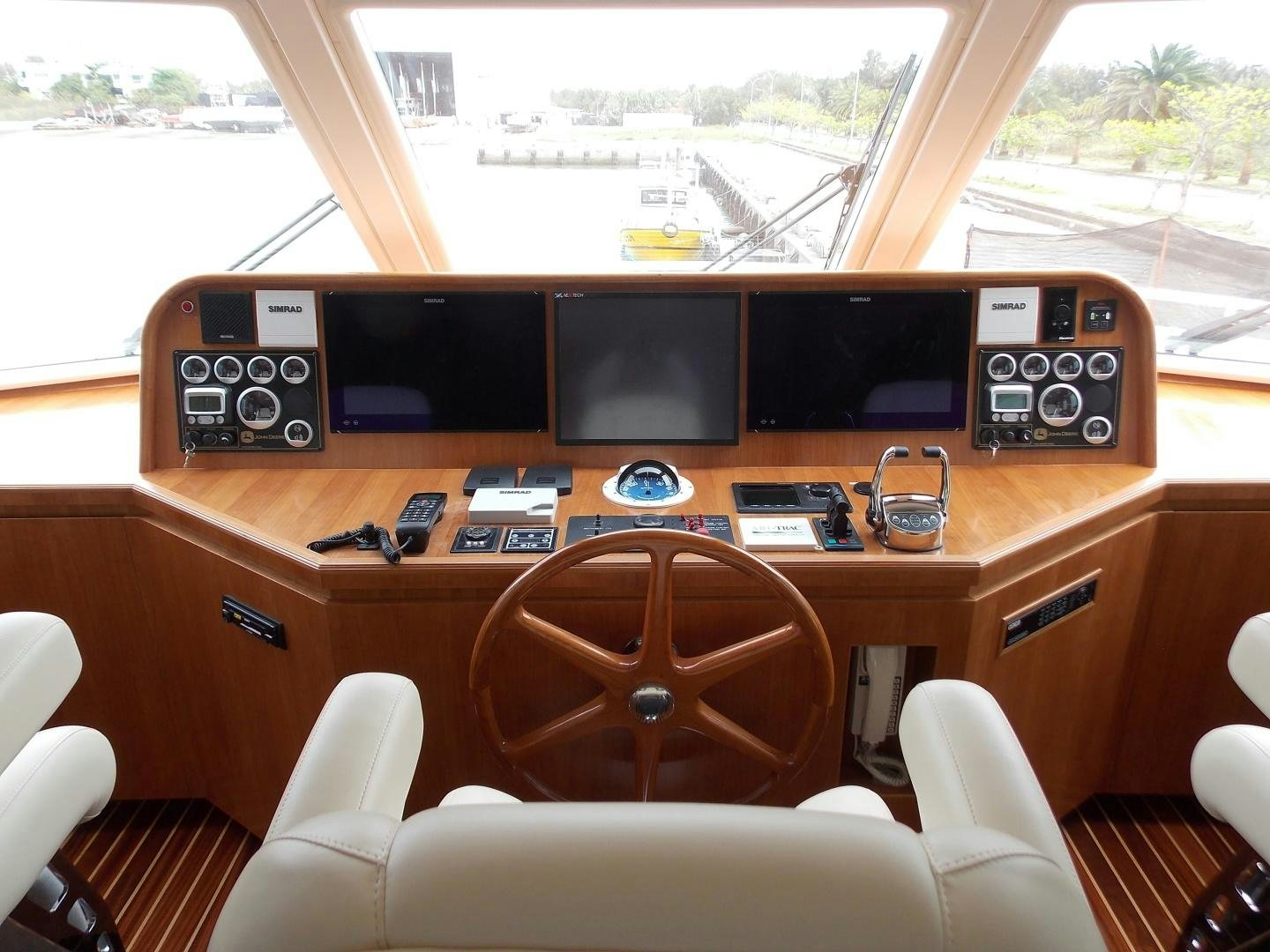 inside of a vehicle with a large screen and a few speakers and a window with a view of aboard LORETTA Yacht for Sale