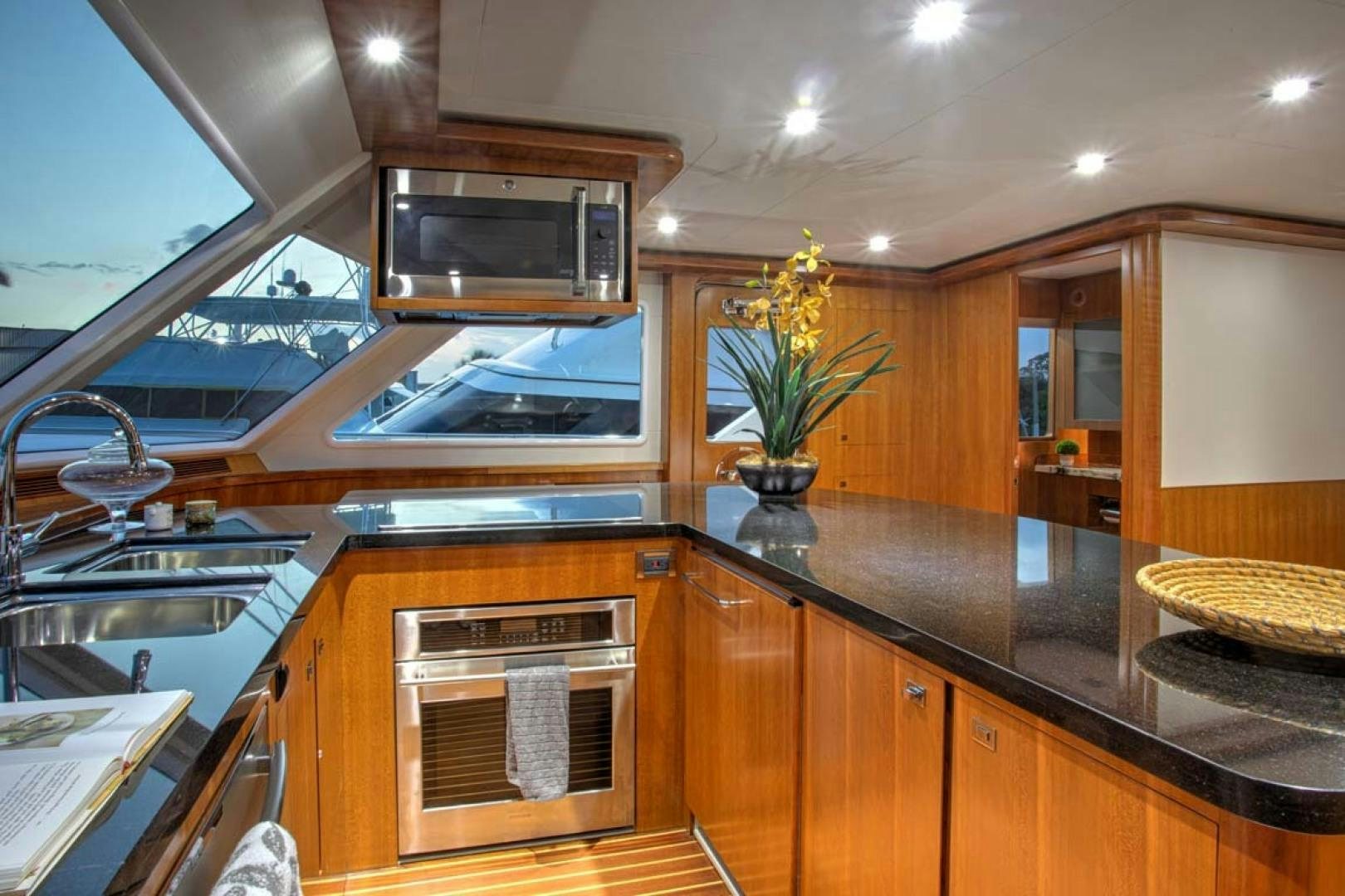 a kitchen with wooden cabinets aboard LORETTA Yacht for Sale