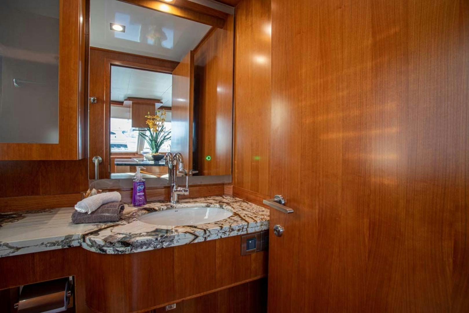 a bathroom with a sink and a mirror aboard LORETTA Yacht for Sale