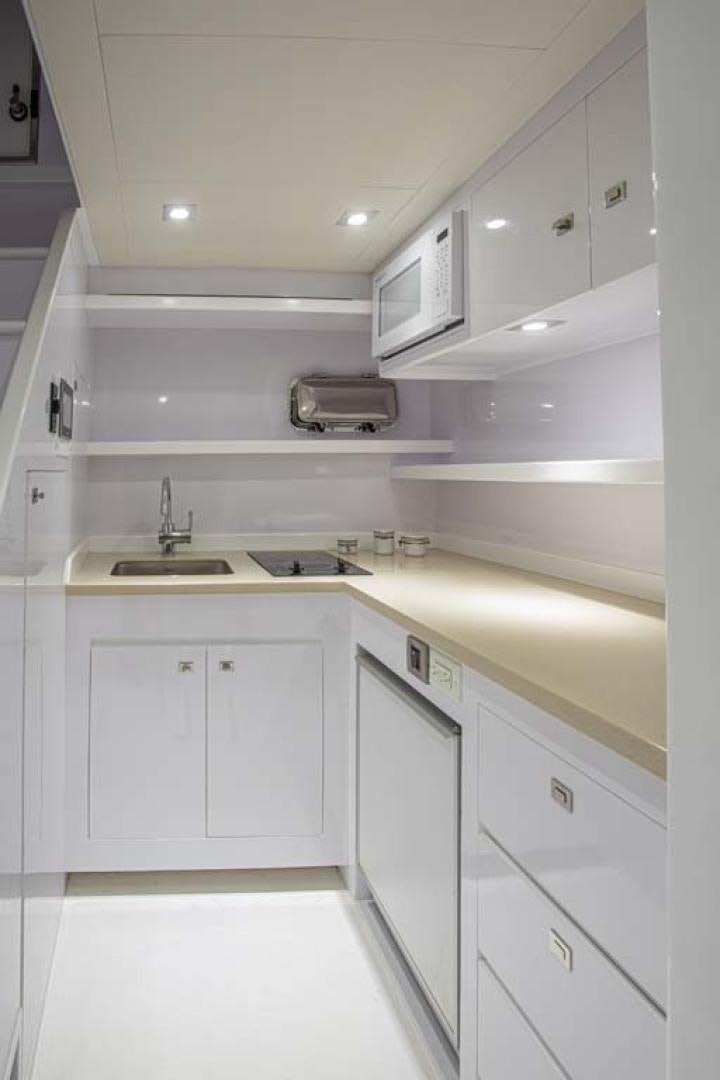 a white kitchen with white cabinets aboard LORETTA Yacht for Sale