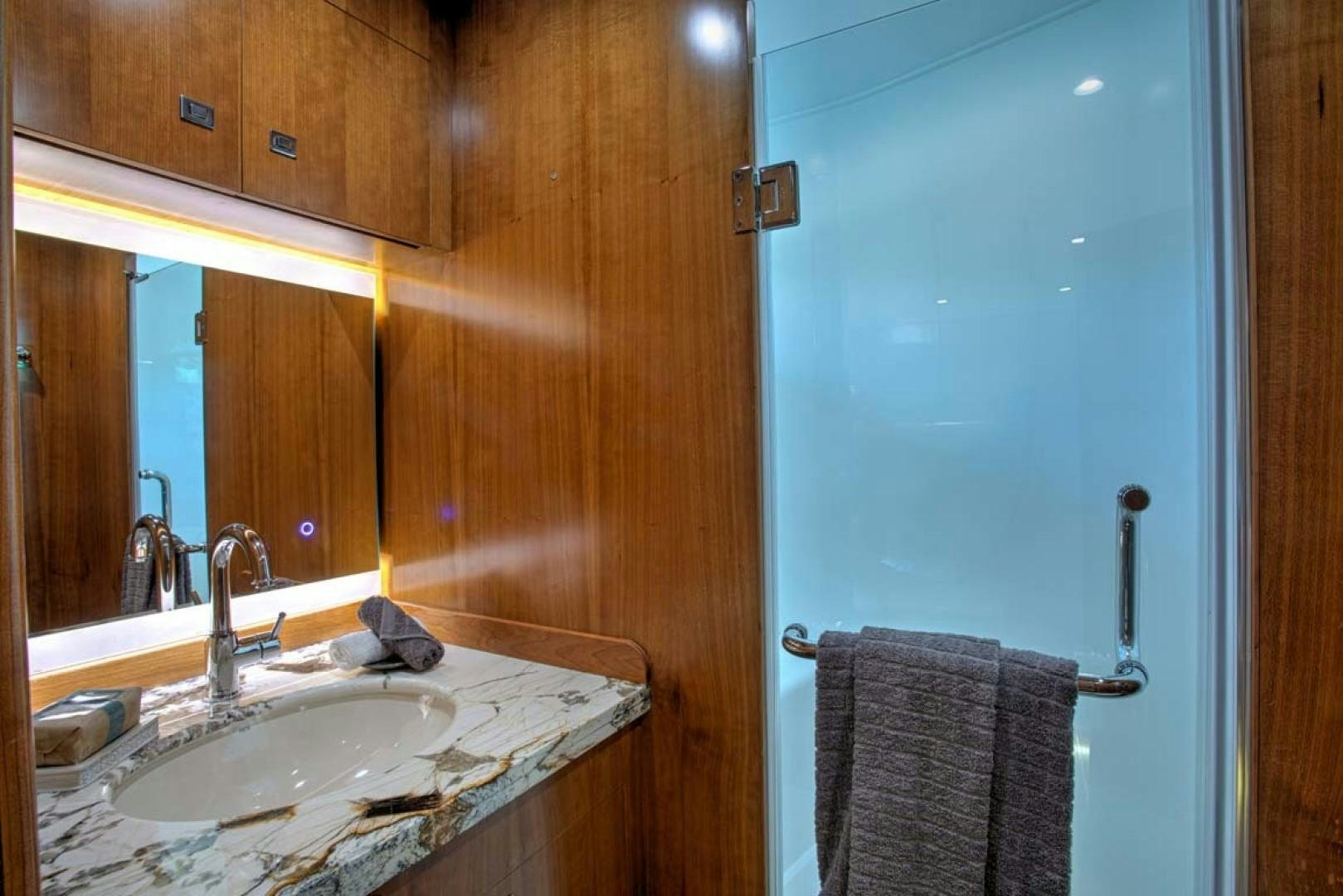 a bathroom with a sink and a mirror aboard LORETTA Yacht for Sale