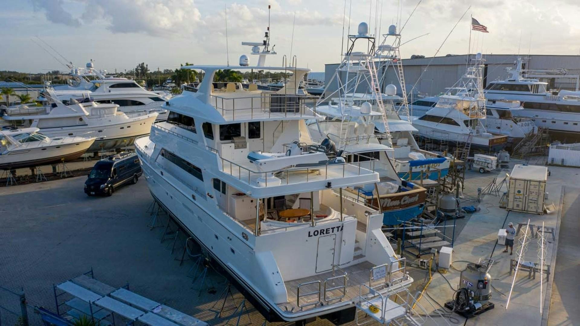 a large white boat docked at a port aboard LORETTA Yacht for Sale