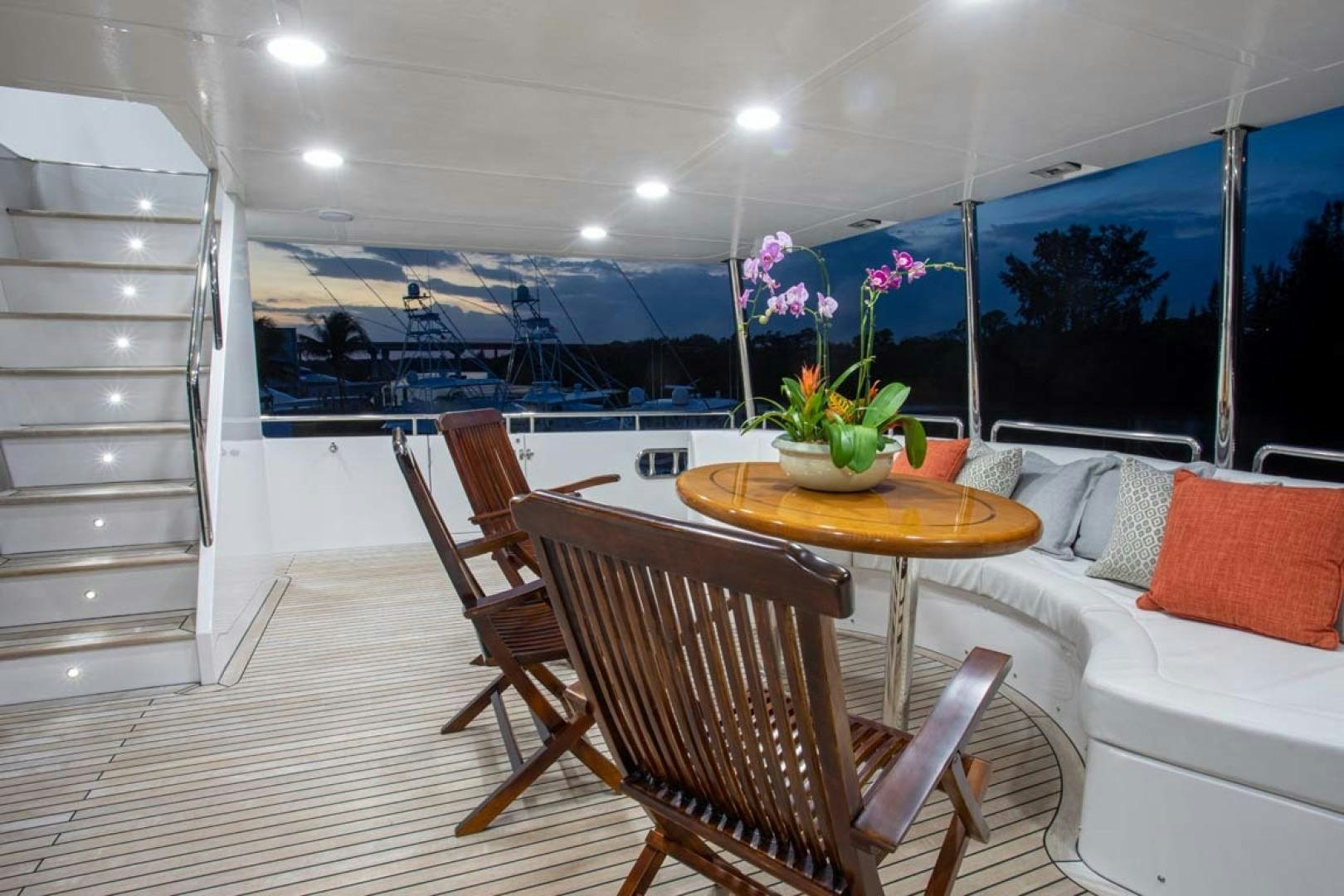 a room with a table chairs and a plant on the table aboard LORETTA Yacht for Sale