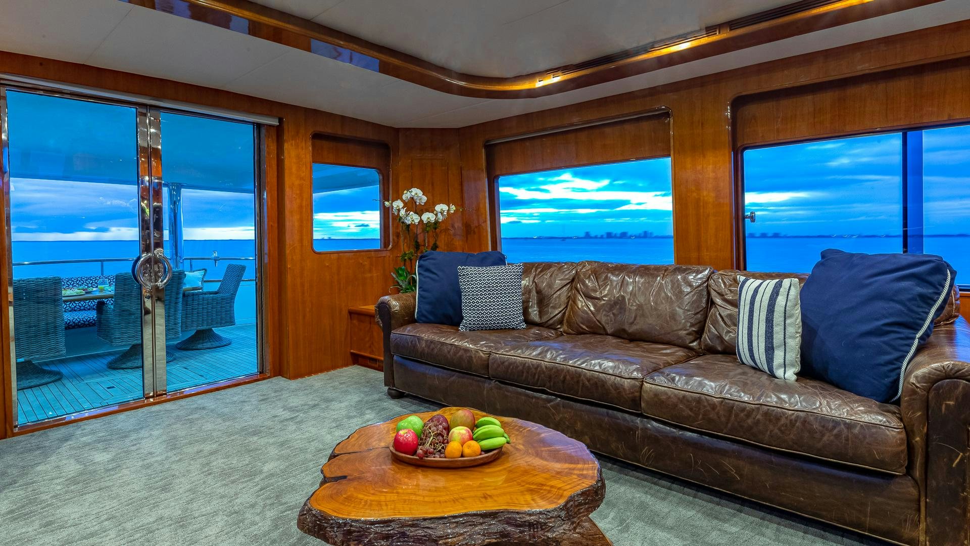 a couch and a table in a room with a view of the ocean aboard SAFARI Yacht for Sale