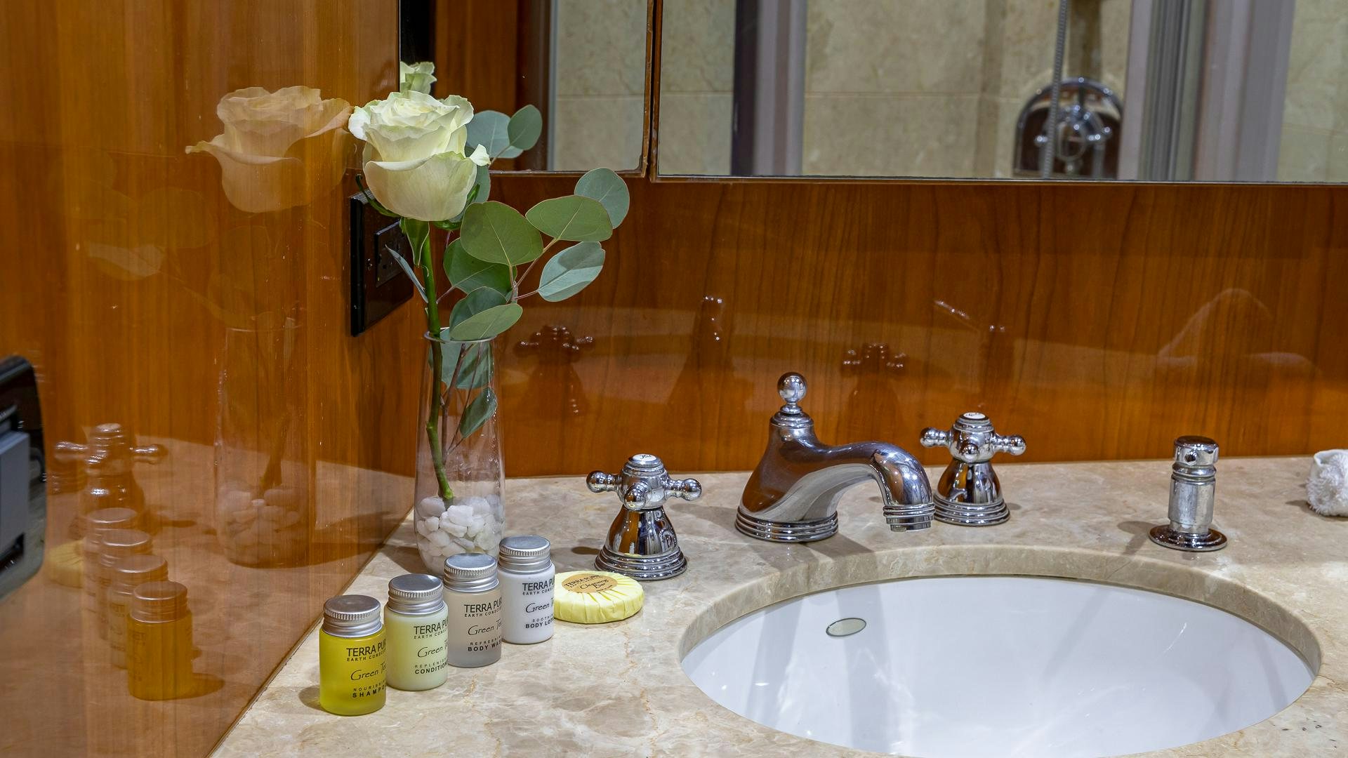 a vase with white roses on a countertop aboard SAFARI Yacht for Sale