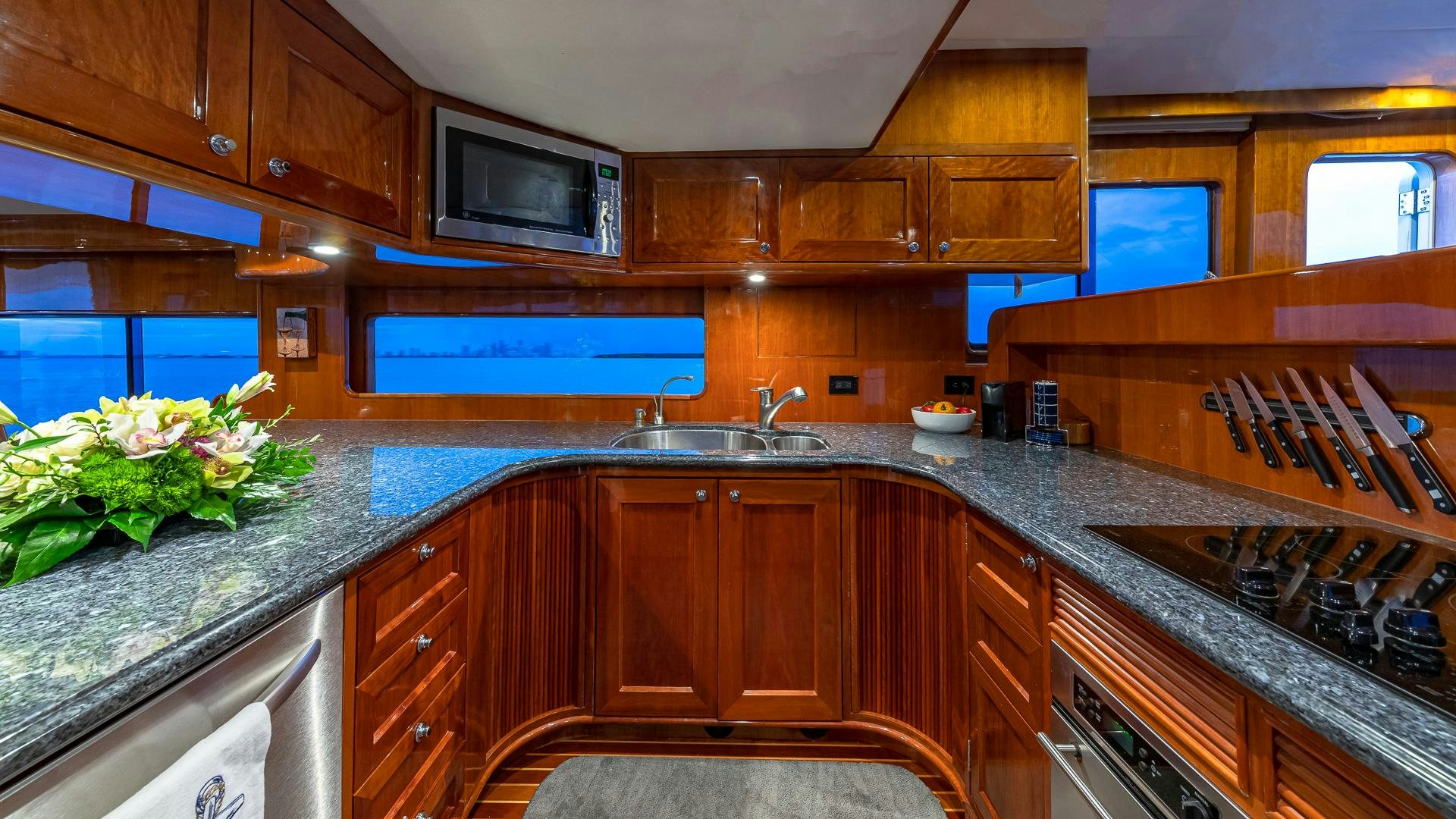 a kitchen with wooden cabinets aboard SAFARI Yacht for Sale