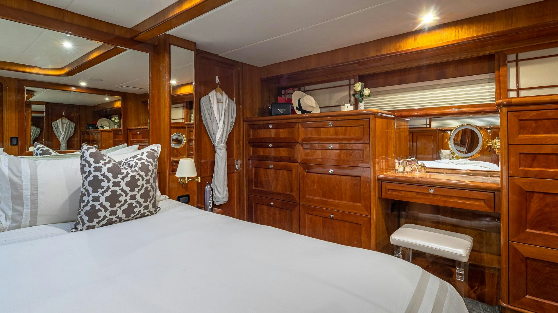 a bed with a white sheet and a wooden headboard aboard SAFARI Yacht for Sale